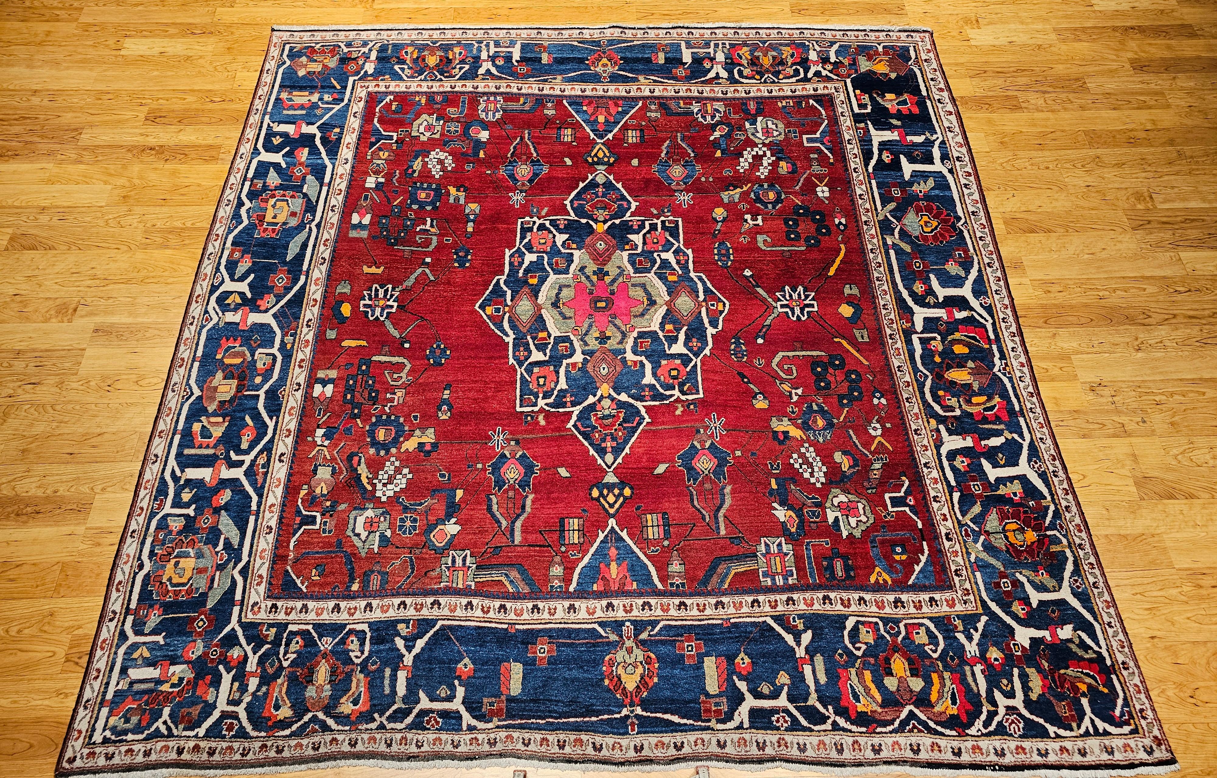 Very rare room size square Persian Hamadan from the mid 1900s in beautiful bright and cheerful colors.  The field color is a brilliant red with the border and the central medallion in abrash French blue.  This wonderful village weaving example has