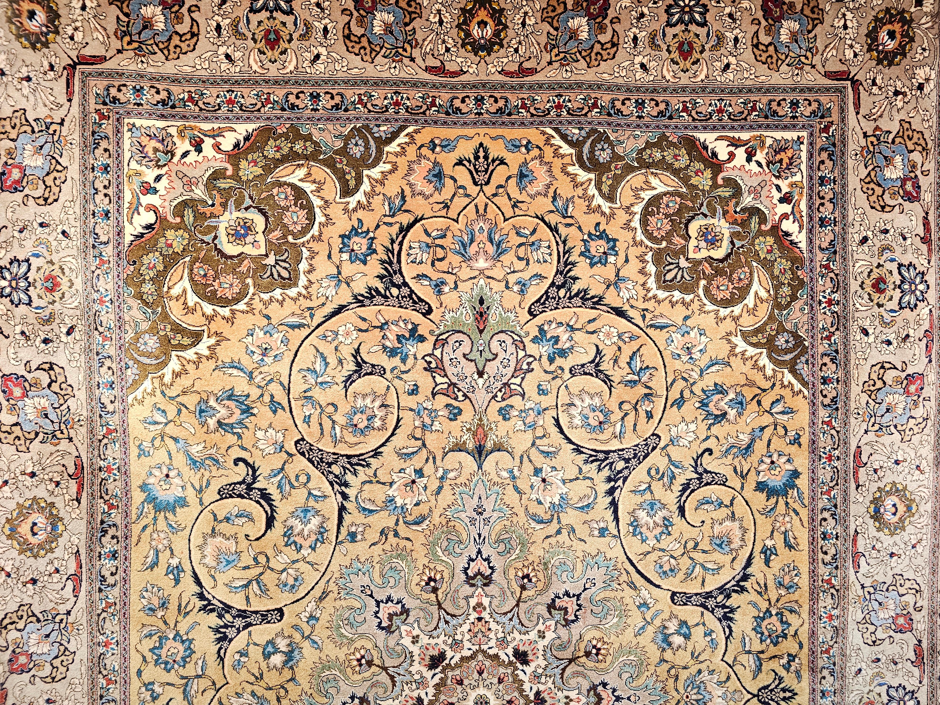 A beautiful room-size Persian Tabriz in a floral pattern with wonderful colors of camelhair, moss green, ivory, and pewter from the early 1900s.  The rug has a wonderful design and a very unique and rare color combination.  It has a caramel or wheat