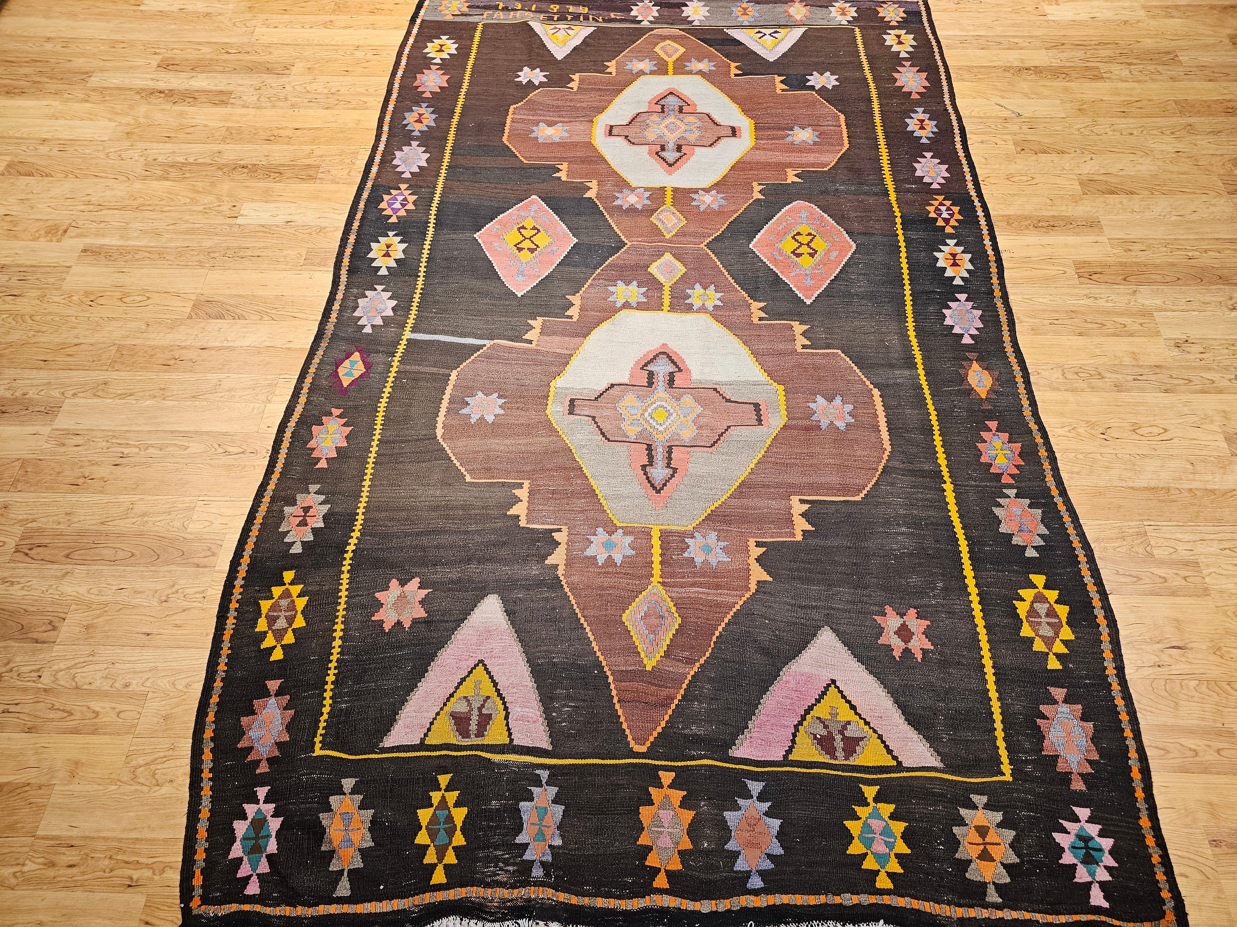 A stunning example of fine modern design blended with traditional craftsmanship, this vintage Turkish kilim rug from the third quarter of the 20th century offers a masterful display of color, texture, and artistry. Handwoven with care, the rug