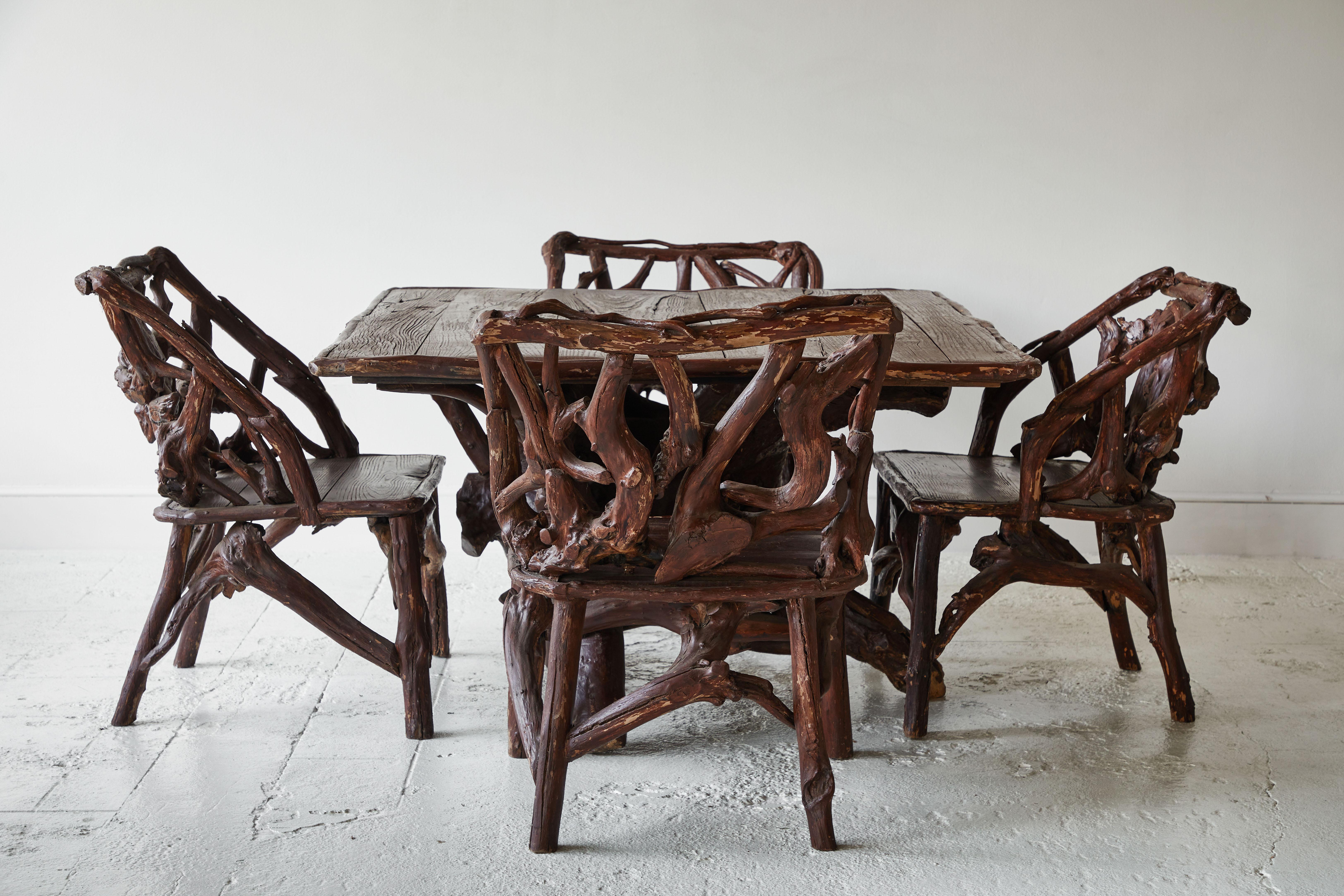 Vintage root table with coordinating set of 4 root chairs. The set boasts character and charm with the root bases. This table and chair is unique and one of a kind. The chairs measure: 25.5
