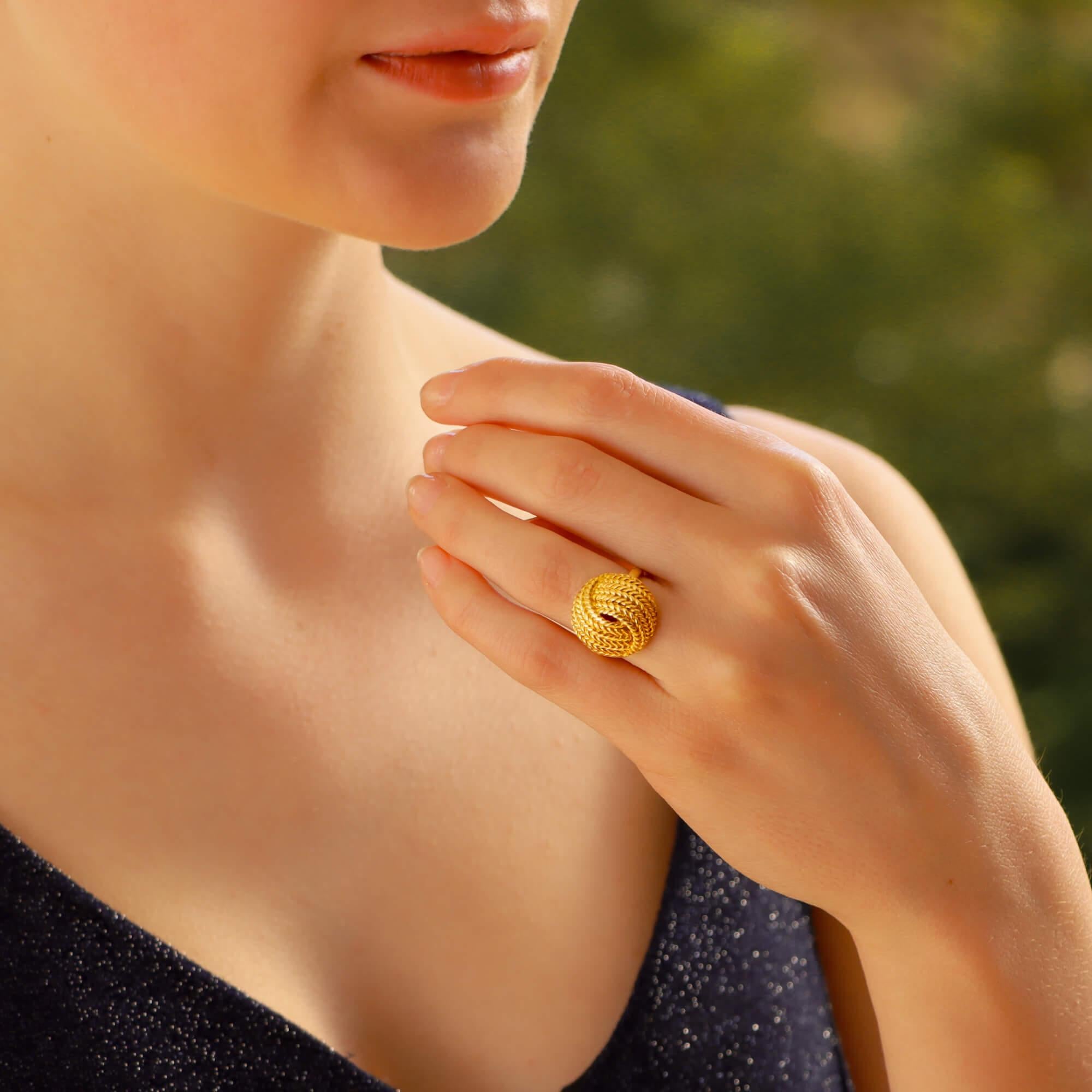 A vintage ropework knot cocktail ring in 18-karat yellow gold. 
This ring is designed as an openwork knot with hand-carved ropework detailing, on a solid D-shape yellow gold shank. 
This ring is a US finger size 4 1/2; UK size J: but could be sized