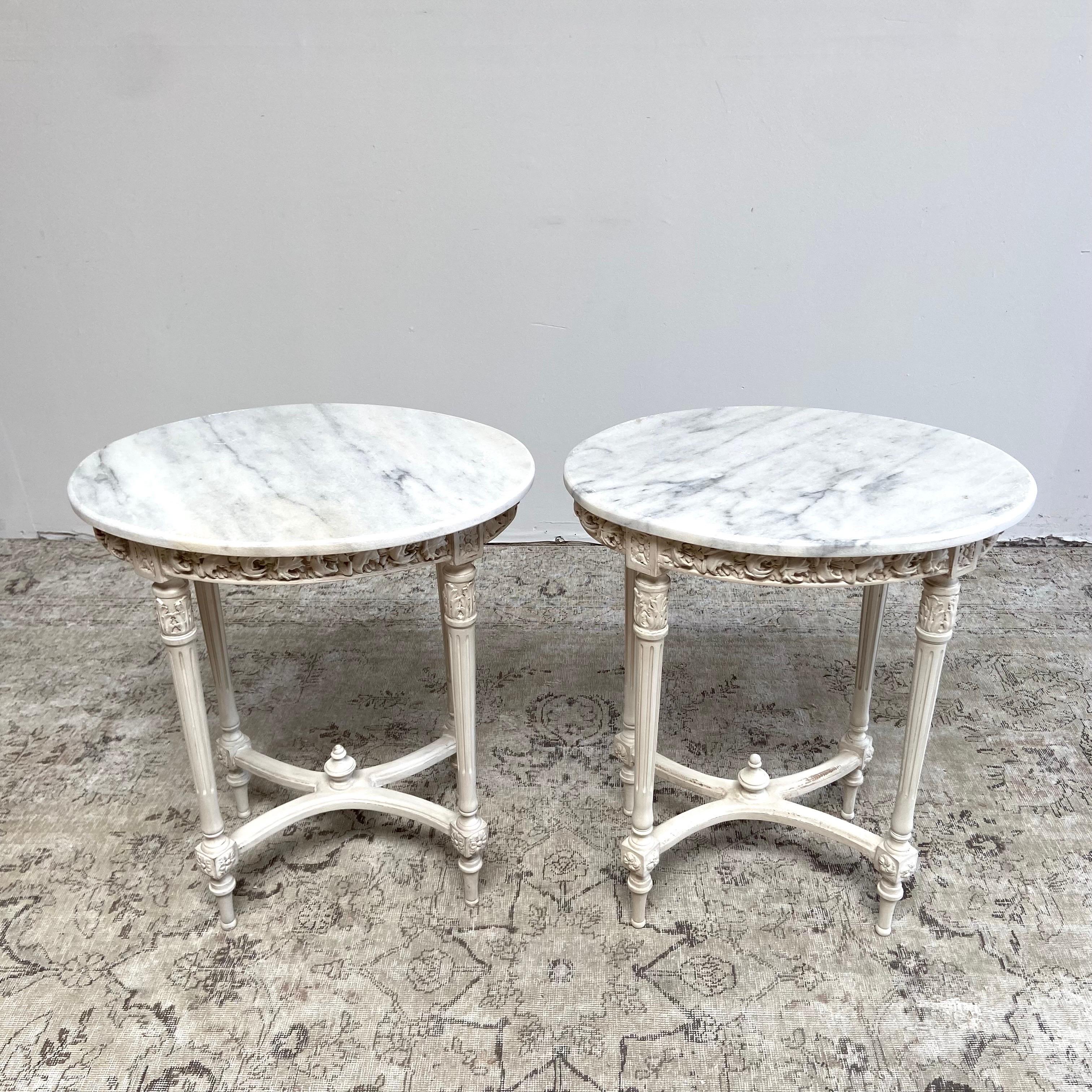 Vintage rose carved oval side table with marble top
Painted in a soft oyster white finish with subtle distressed edges and antique glazed patina.
Rough natural cut marble, semi-honed finish. 
Size: 25” W x 19” D x 29” H
Sold individually please