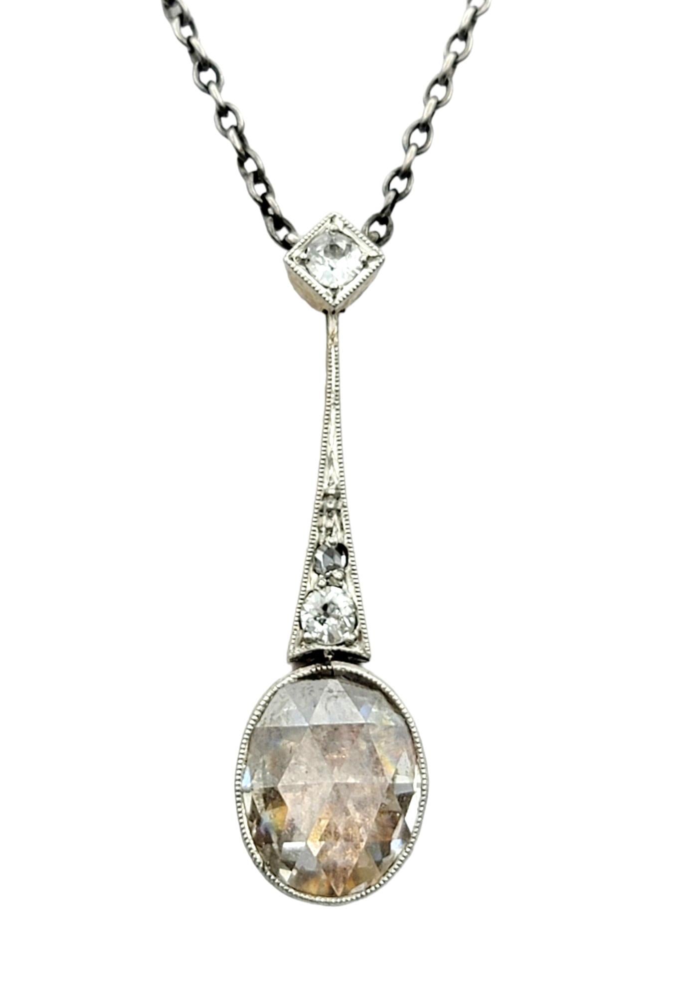 This vintage pendant necklace featuring a stunning combination of oval rose-cut and round-cut diamonds is set in luxurious 14 karat gold. The pendant showcases the timeless elegance of rose-cut diamonds, complemented by the brilliance of round-cut