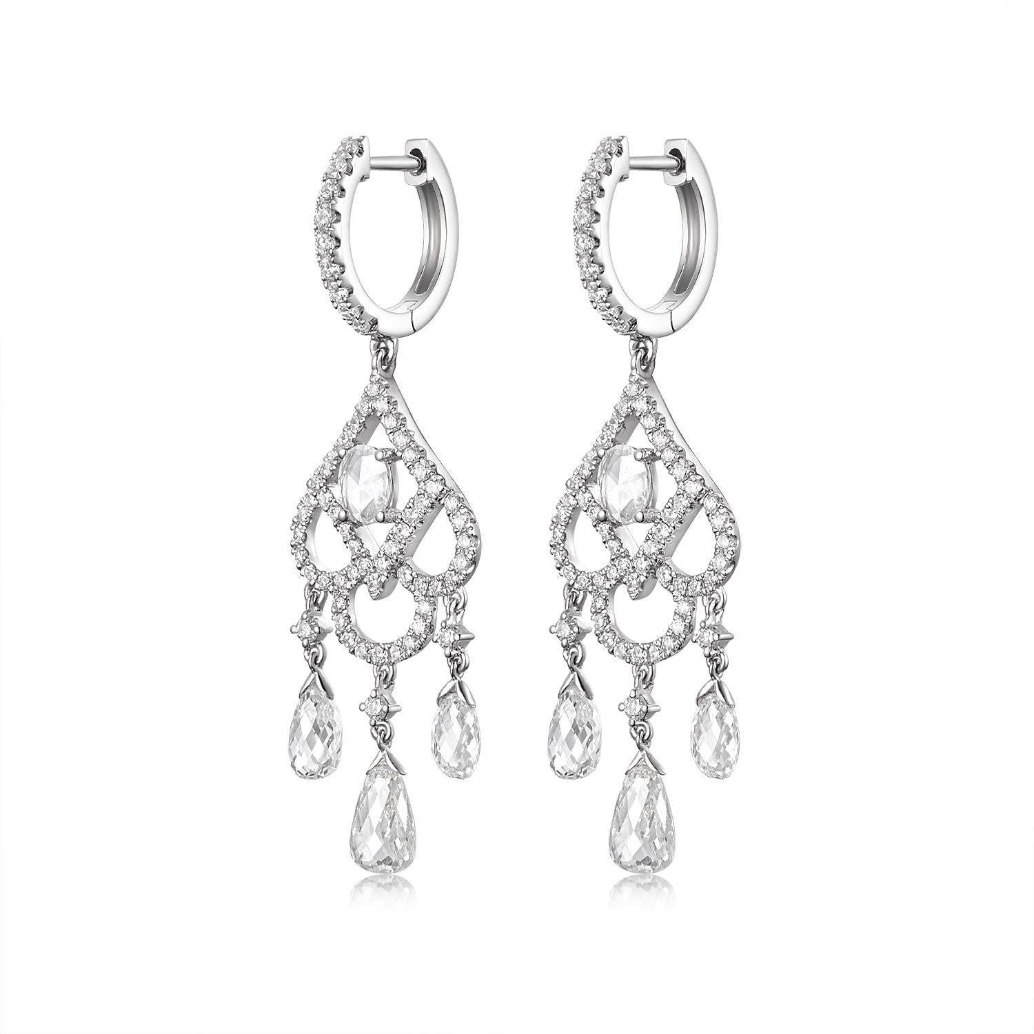 Embrace the timeless elegance of yesteryears with these stunning antique dangle earrings, meticulously crafted in lustrous 18 karat white gold.

At the heart of each earring lies a shimmering rose cut diamond, weighing a collective 0.2 carats. Known