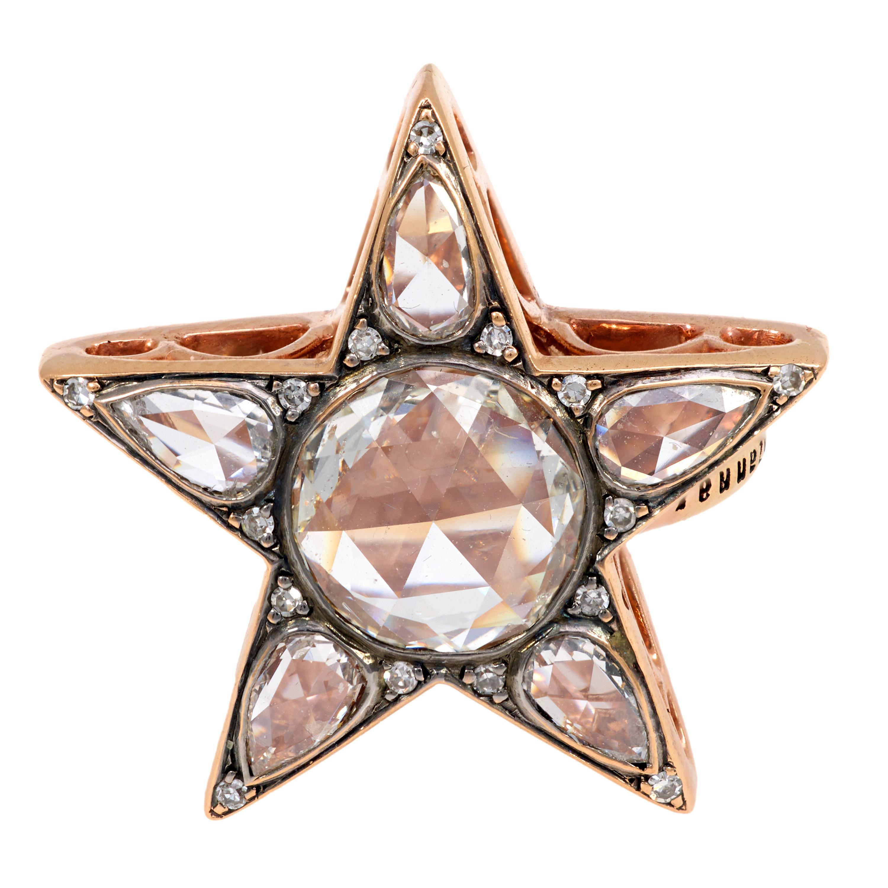 This vintage 18k rose gold ring radiates with celestial charm, centering a 0.90 carat rose cut diamond encircled by pear-shaped rose cuts and shimmering single cut accents. Designed in a starburst motif and crafted in the 1990s, this richly detailed
