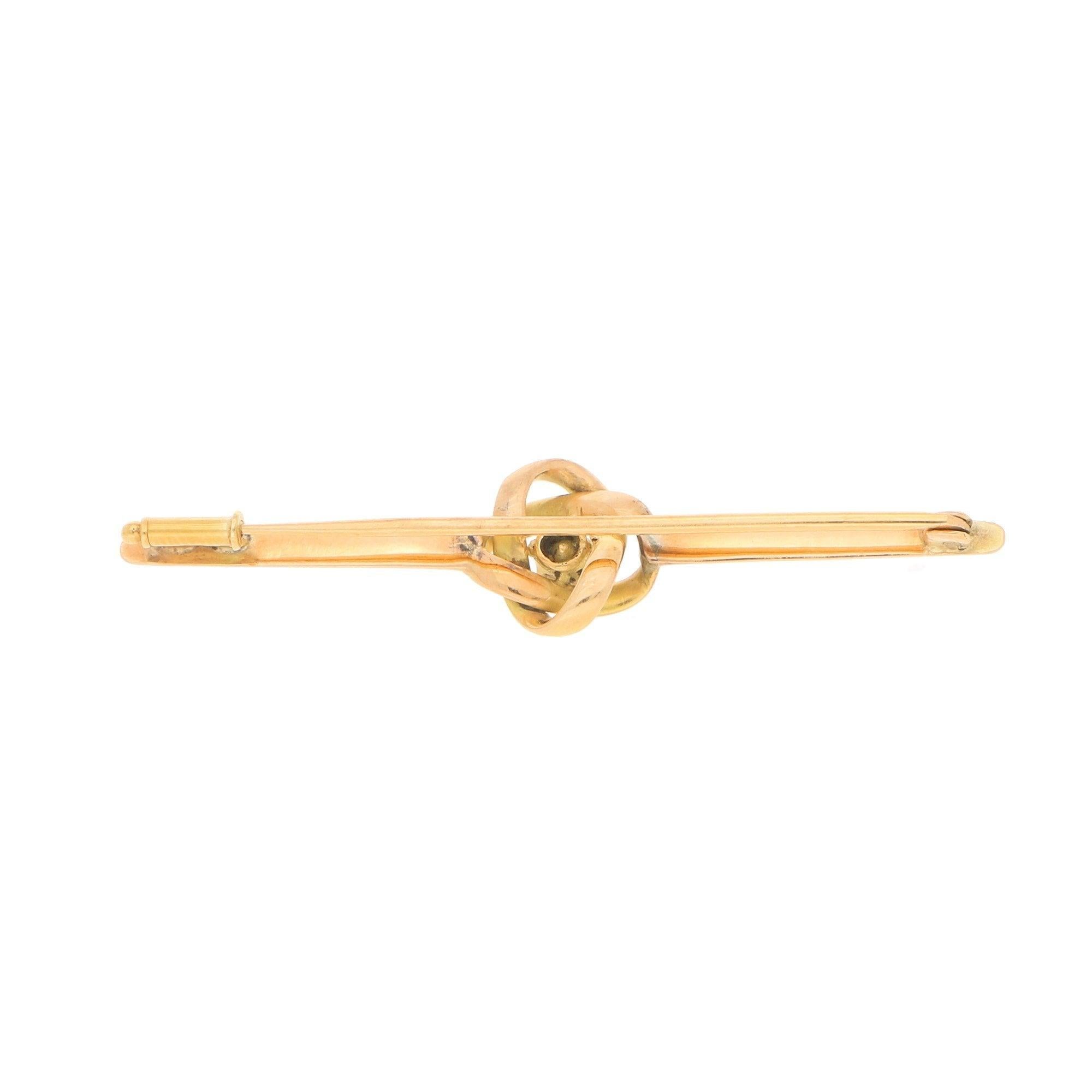 Diamond approximately 0.02 carats.

A simple vintage rose-cut diamond knot bar brooch in rose gold. 
The brooch of the bar design features a central openwork knot motif, set to the centre with a rose-cut diamond in a close-back setting. 
The brooch