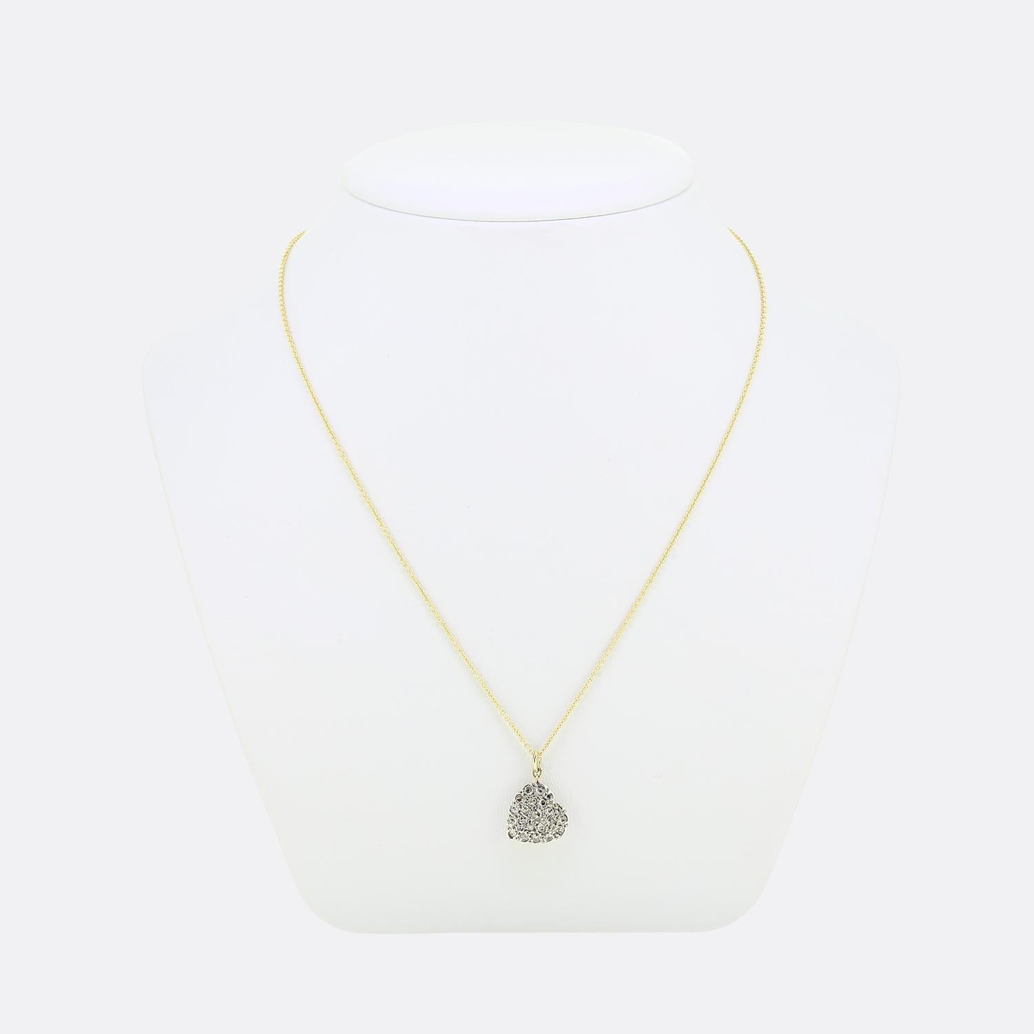 Here we have a gorgeous diamond set pendant necklace. This pendant has been crafted from 18ct yellow gold into the shape a love heart and platinum pave set with a multitude of rose cut diamonds of differing sizes which results in a radiant ensemble.