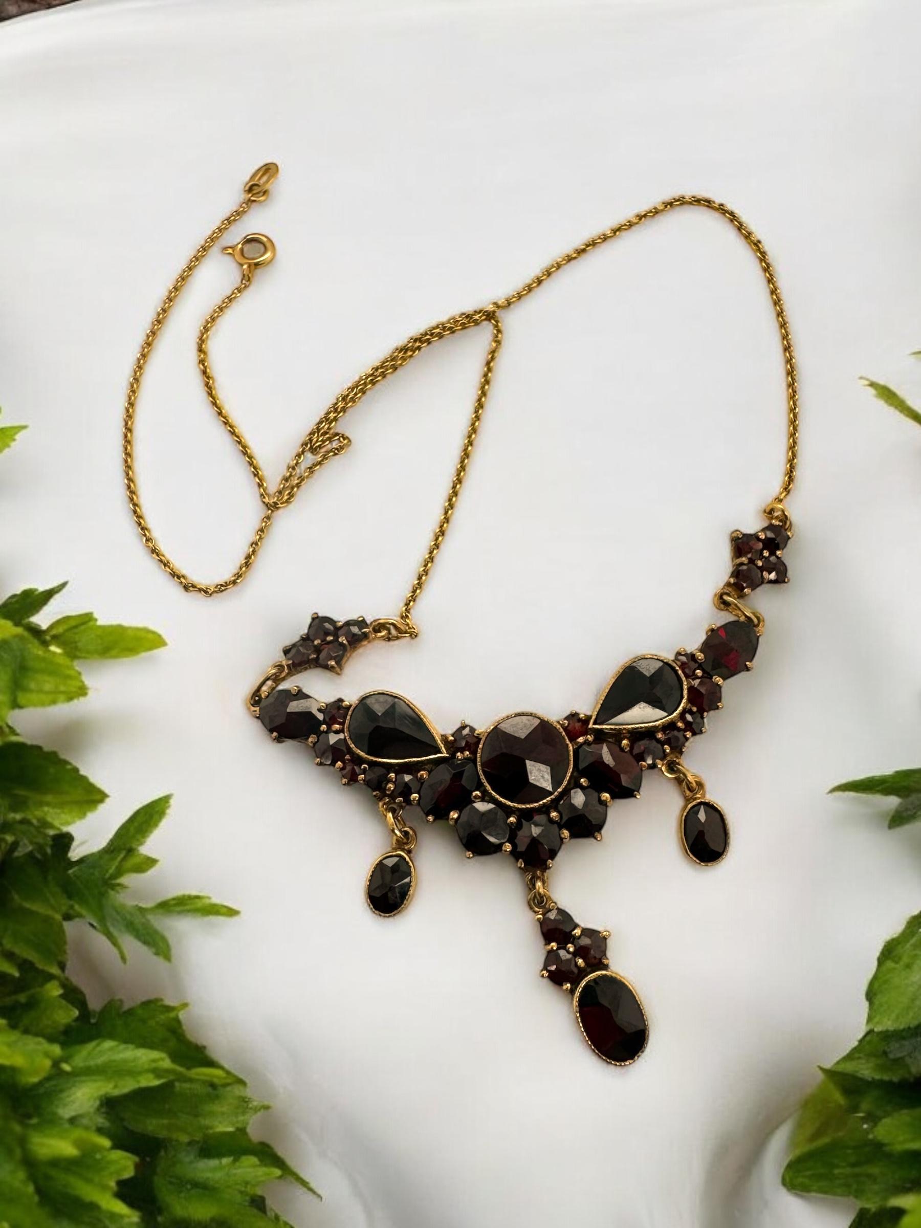 We are loving this unique vintage beauty!!

Necklace Details
Material: 10K Rose Gold
Weight: 8.8 Grams
Length: 15 1/2 Inches

Accented by the following gemstones
36 - Custom Rose Cut Garnet Gemstones Varying Shape & Size