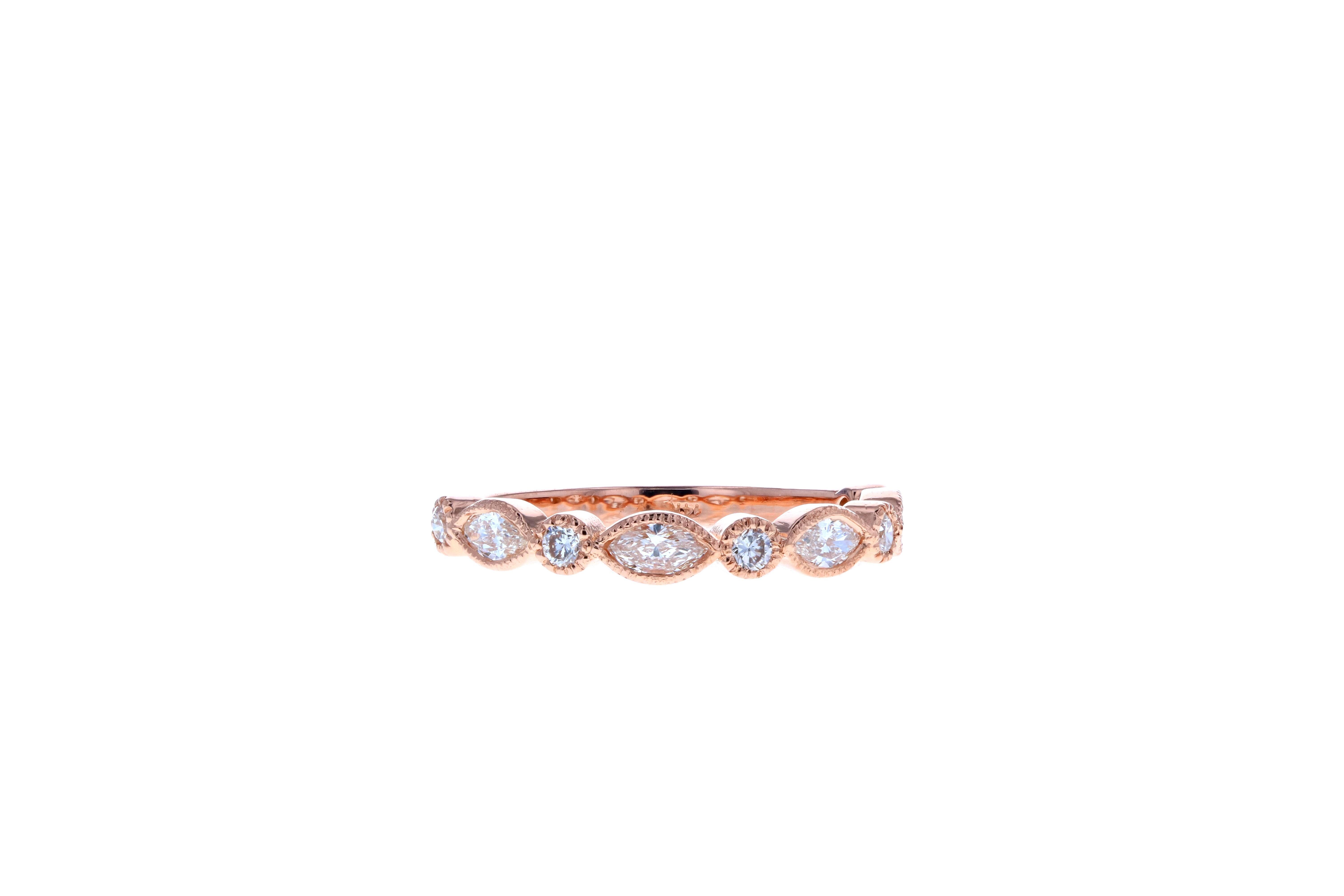 This beautiful vintage style wedding band is made in 14K rose gold and alternating round and marquise diamonds. With a high polish and milgraine accents, it's a stunning wedding band that will accentuate a matching engagement ring or diamond