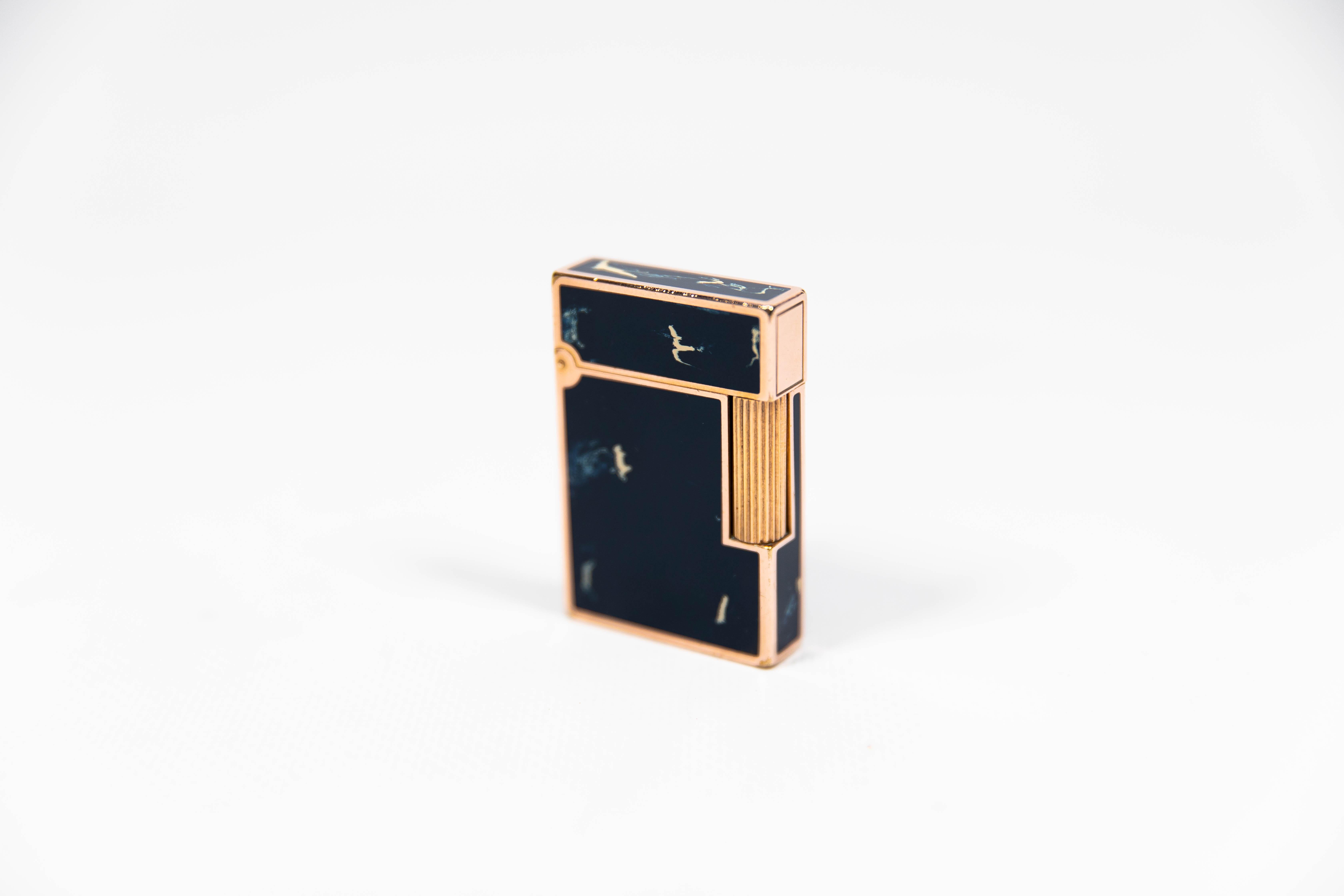 Vintage Authentic 24k Gold plated Ligne 2 ST Dupont Lighter in blue Lacquer 1990s 

The iconic S.T. Dupont name is known for quality, well-made cigarette lighters and other luxury implements. The company’s origin can be traced to Simon Tissot-Dupont