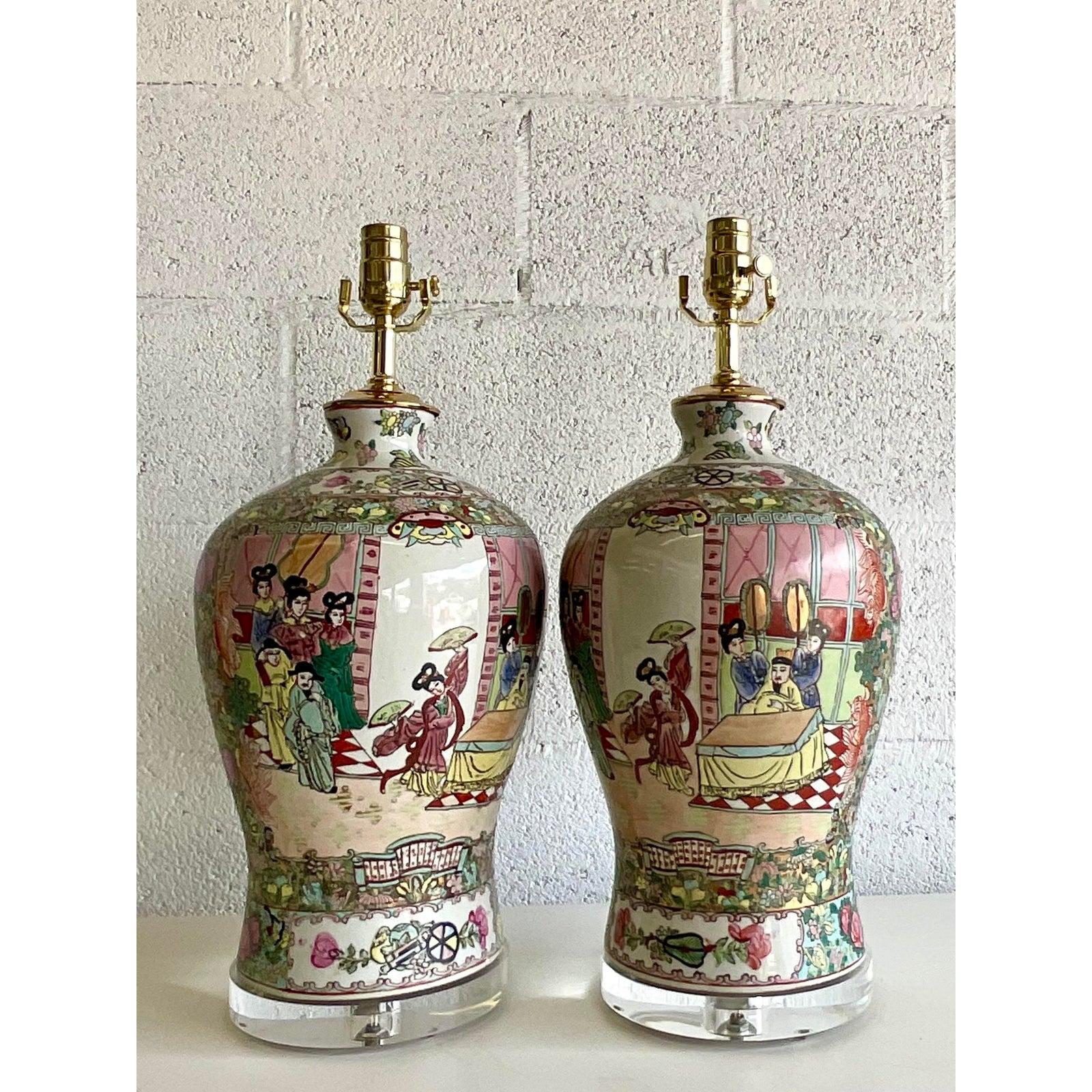 Stunning pair of vintage Rose Medallion table lamps. Iconic pastoral scenes of a royal family. Bright clear colors make these lamps a real standout. All new wiring and hardware and a new lucite plinth. Acquired from a Palm Beach estate.