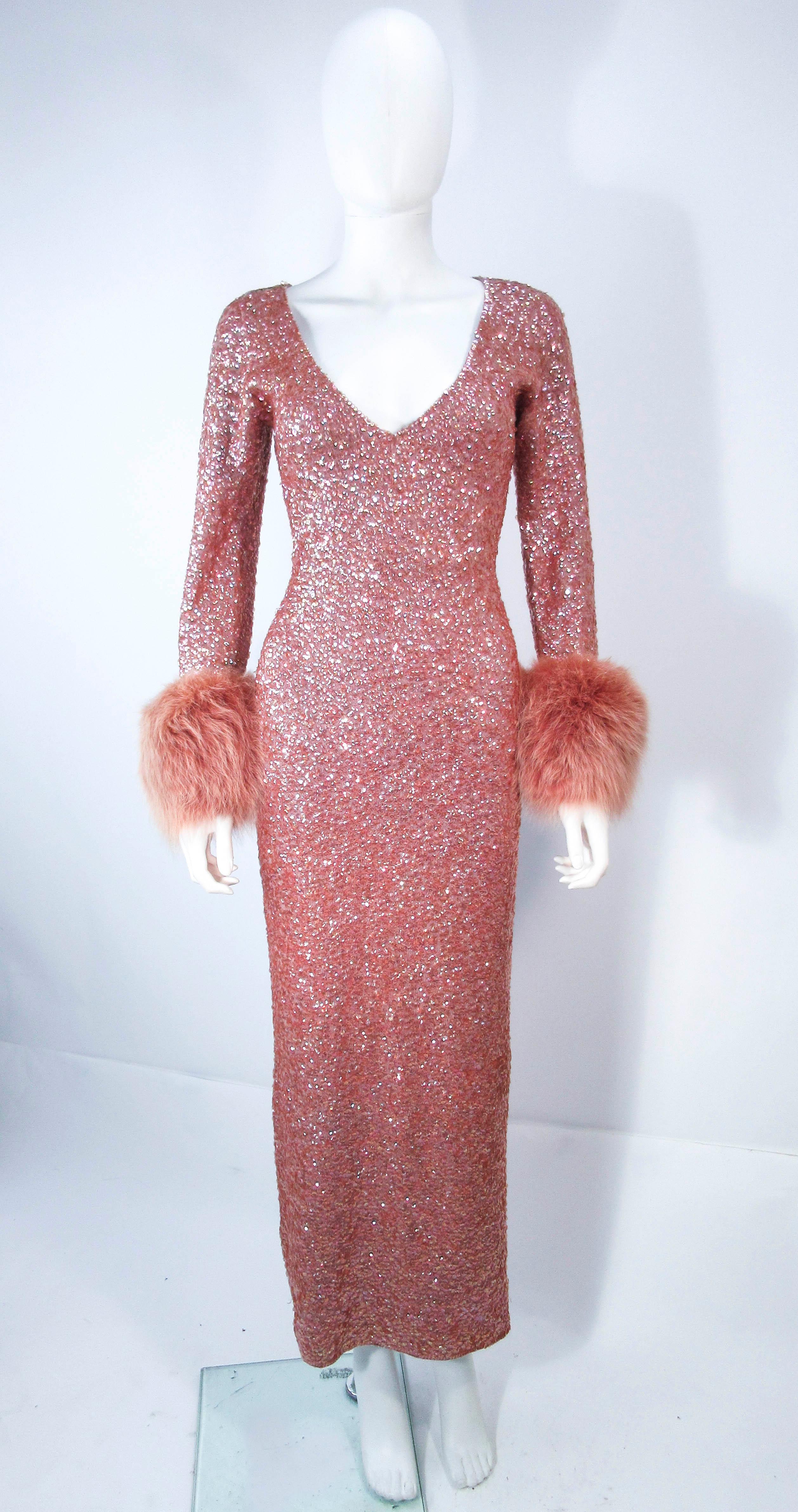 This is a fantastic vintage design, which is composed of a pink/apricot hue knit wool with iridescent sequin applique. Features fox fur cuffs. This is a pull on style which can be style with the v-plunge front or to the back. In excellent vintage