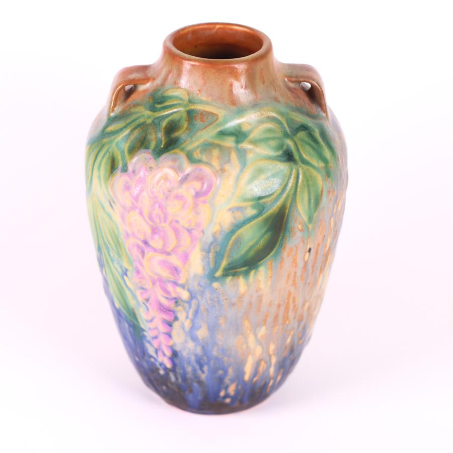 Offering this fabulous Roseville, American art pottery vase in the Wisteria pattern from 1933. This genuine Roseville art pottery vase is hand-painted with a gorgeous 