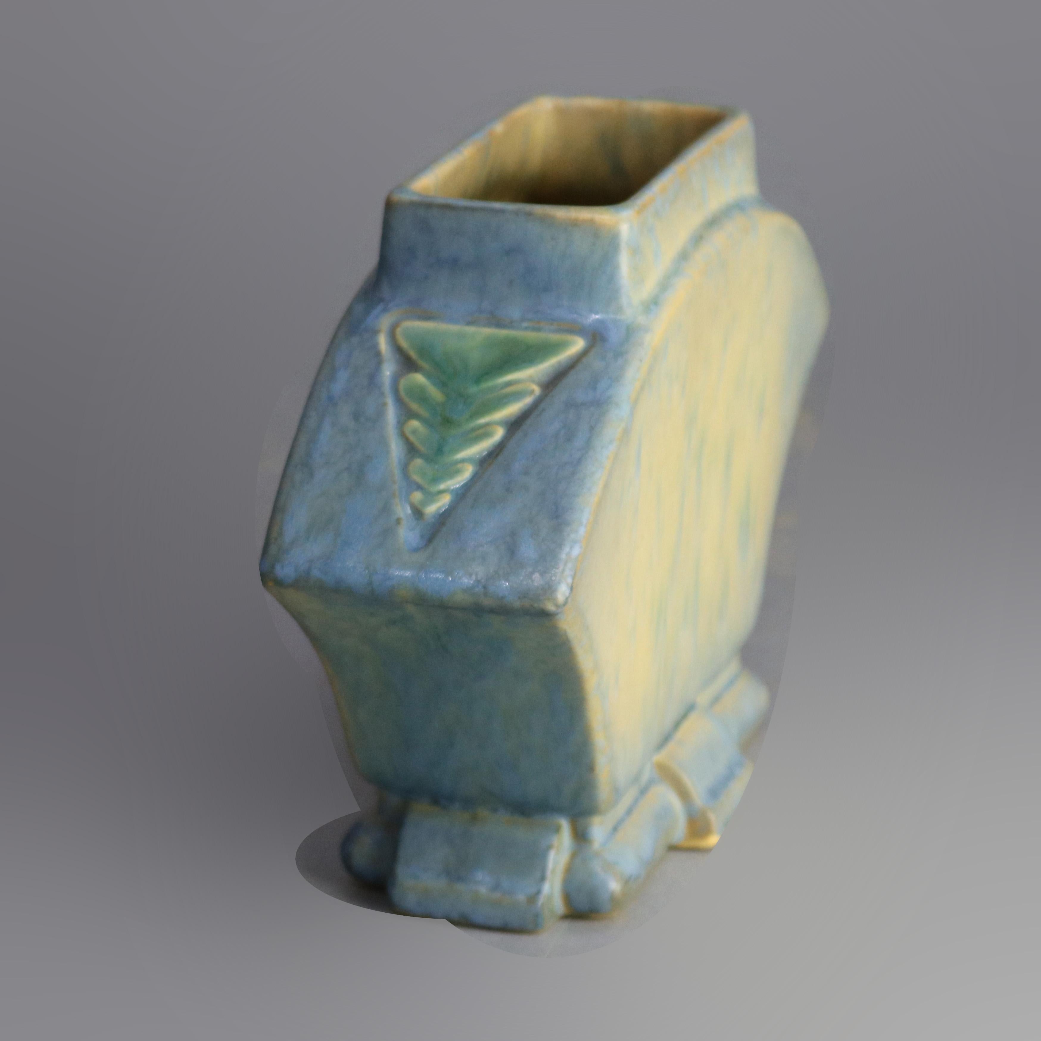 A vintage art pottery Roseville Futura buttress vase with rectangular mouth having flanking stylized arrow elements reminiscent of southwestern styling, missing the label, c1930

Measures: 6.25