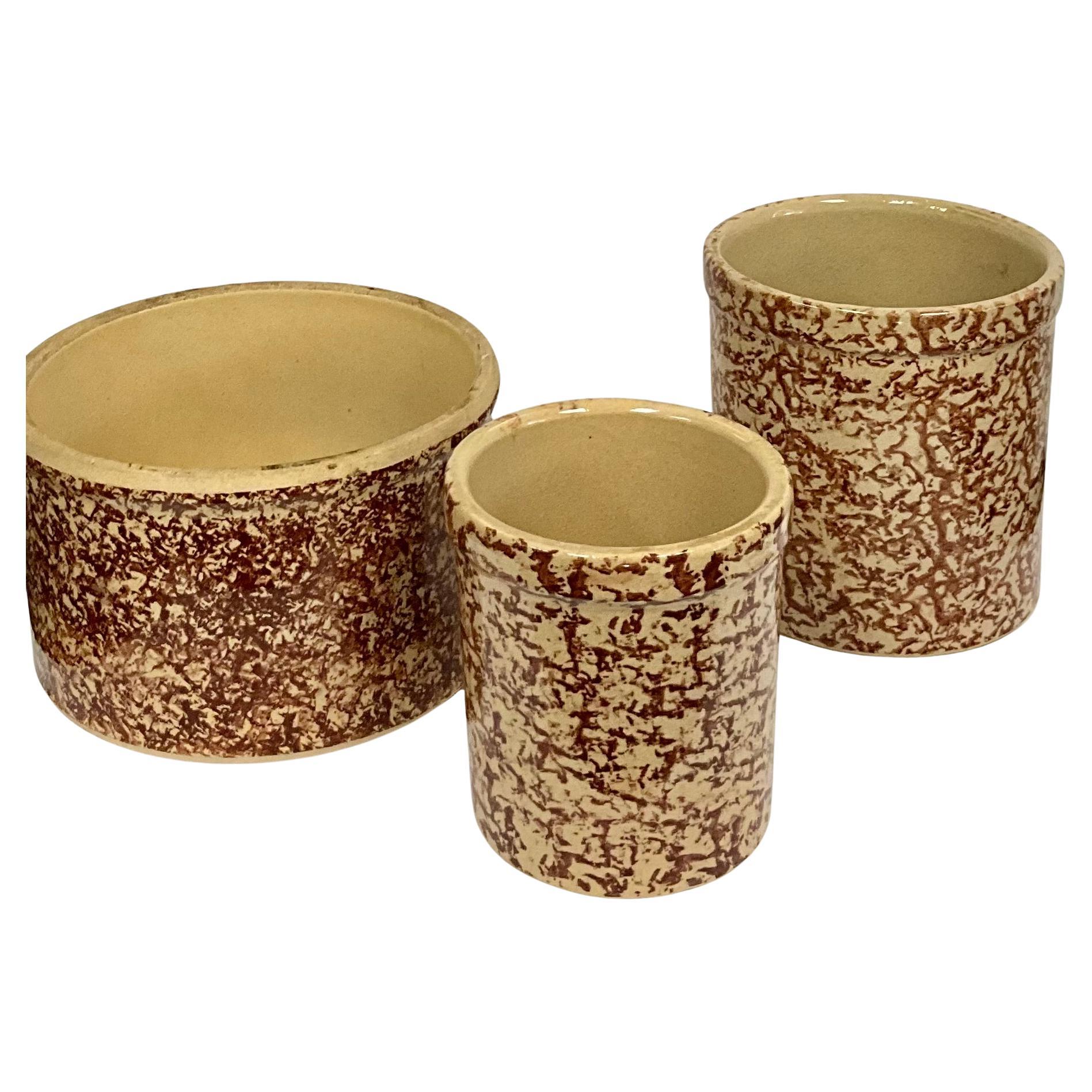 Vintage Roseville Spongeware Crock Pots Set of Three
 This charming set of three vintage Roseville spongeware crock pots features a classic brown spongeware design, showcasing the craftsmanship of the Antique R.R.P. Co. from Roseville, Ohio, U.S.A.