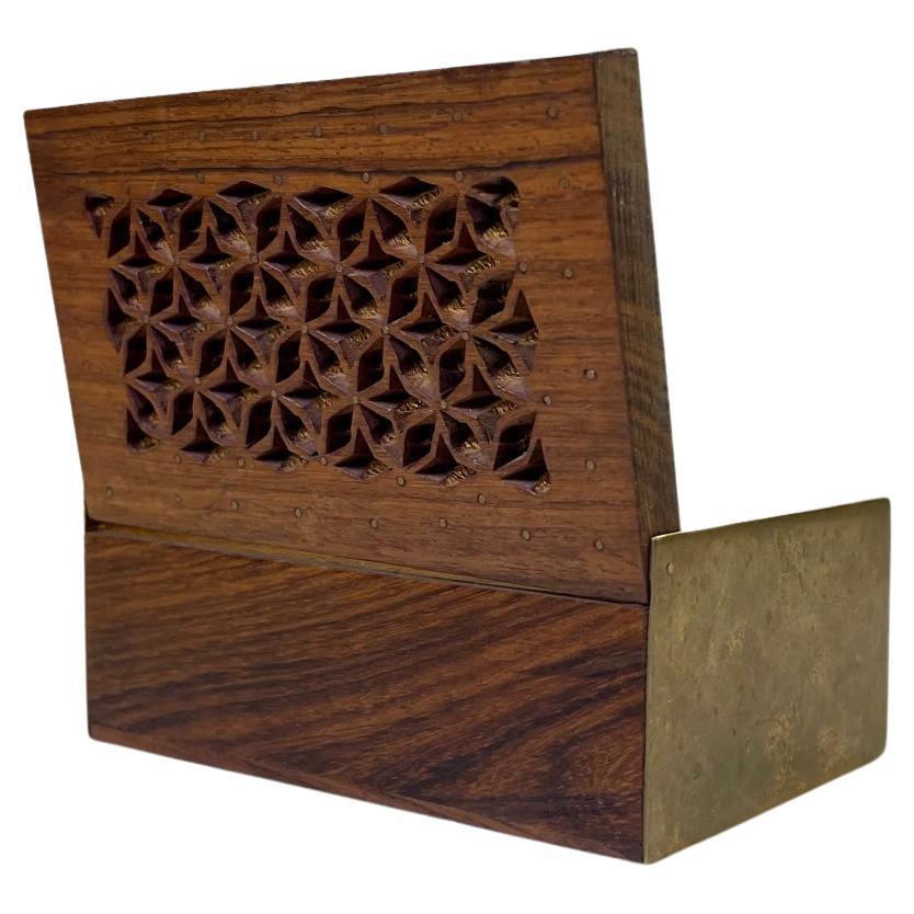 A beautifully crafted rosewood box with brass sides and pin-inlays to its star-perforated lid. Despite its Arabic inspired lid it was in fact made in Scandinavia during the 1960s. A style reminiscent of Alfred Klitgaard. It has no markings.