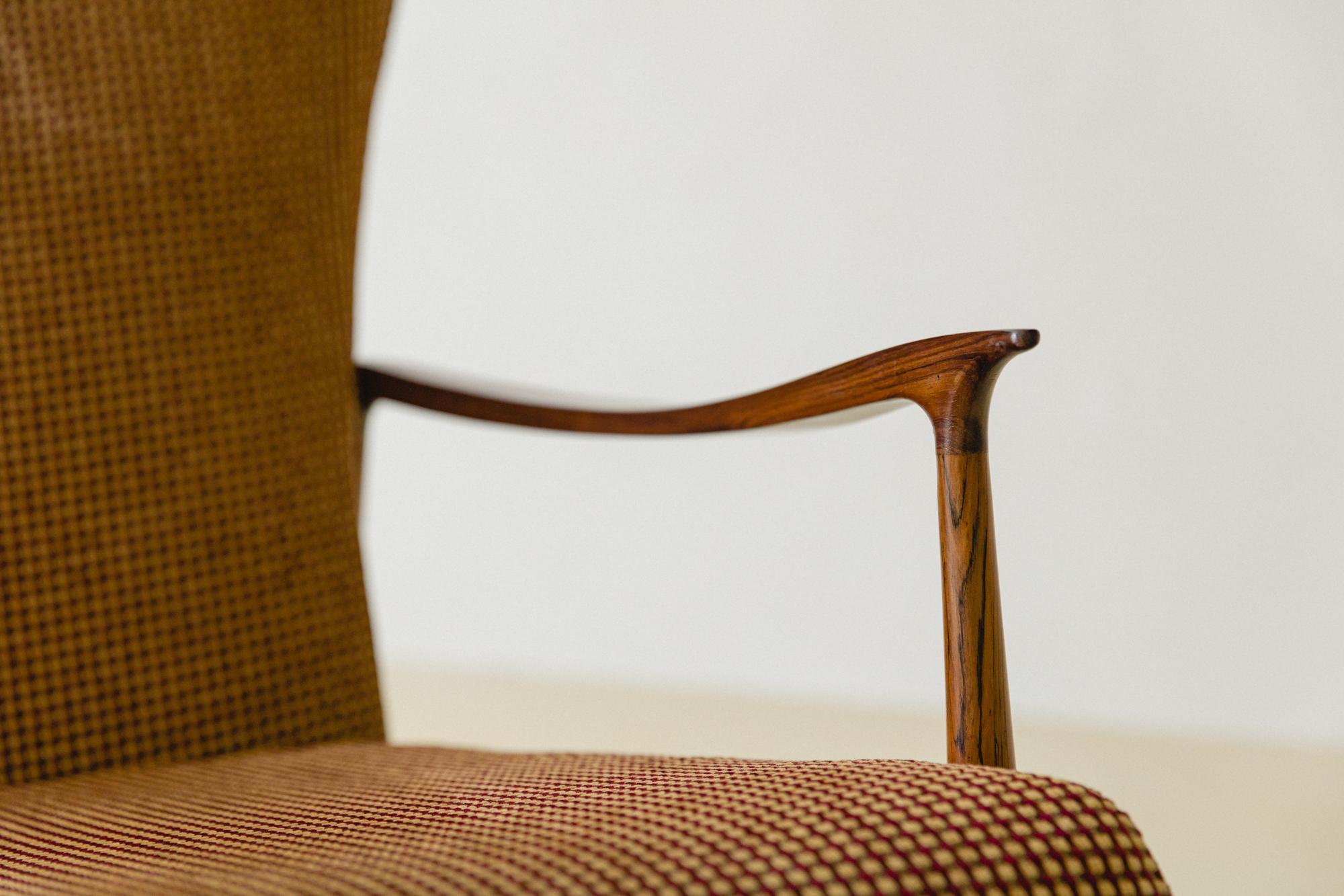 This rosewood armchair was produced in the 1950s by the Brazilian company Móveis Cimo, a Pioneer in Brazilian furniture industrialization. 

Cimo's history starts in 1921 with a wood boxes factory called A.Ehrl e Cia. and ends in 1982 as a