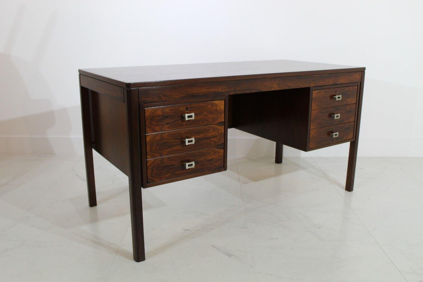 Rosewood Danish 1960's Desk with metal square brushed chrome handles set over 6 drawers.

Beautiful desk boasting a striking Rosewood grain, this piece has been newly re polished.