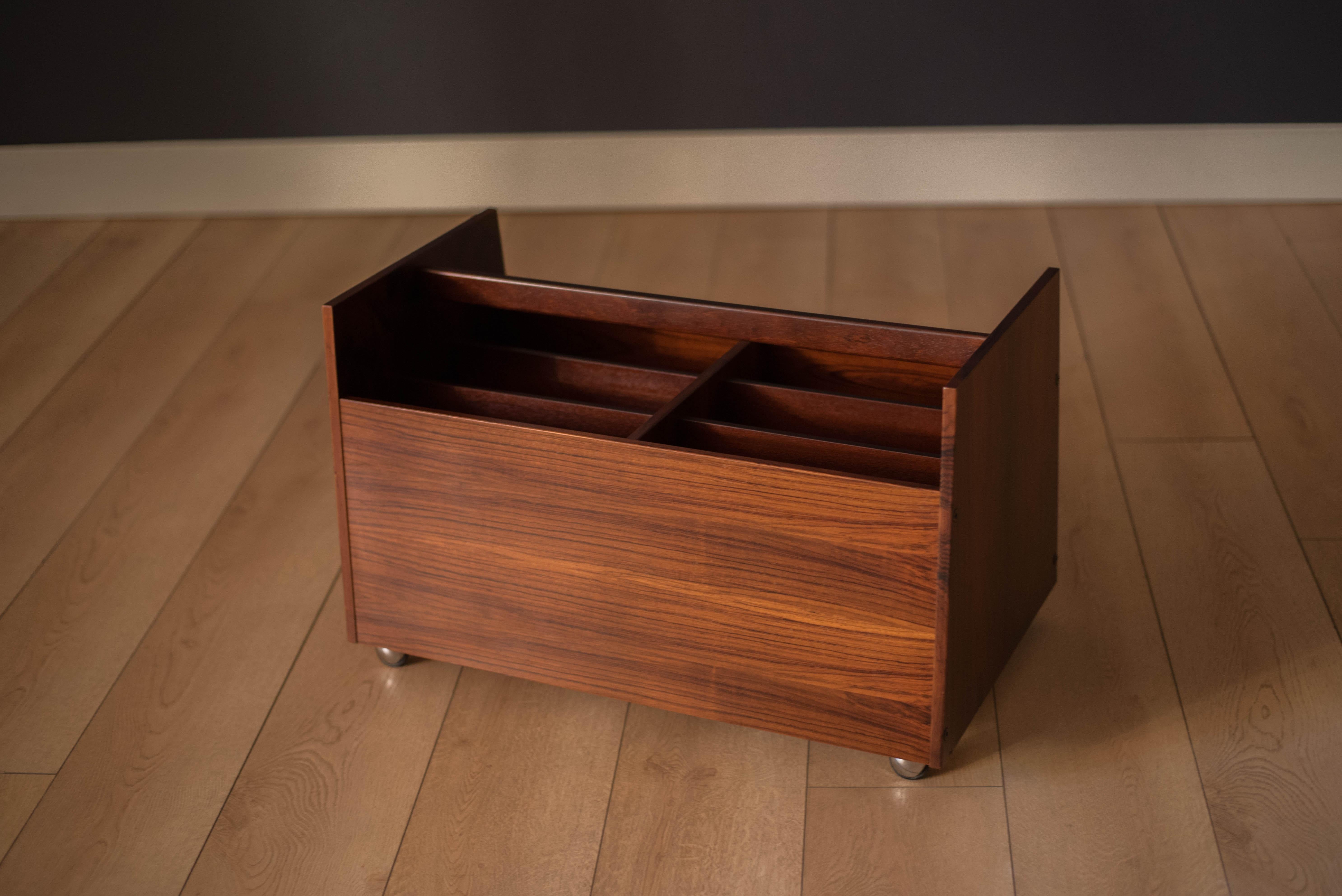 Mid century modern magazine LP vinyl record storage cart designed by Rolf Hesland for Bruksbo, Norway. This piece features stunning Brazilian rosewood grains that showcase from any angle. Equipped with six organizing compartments and four casters