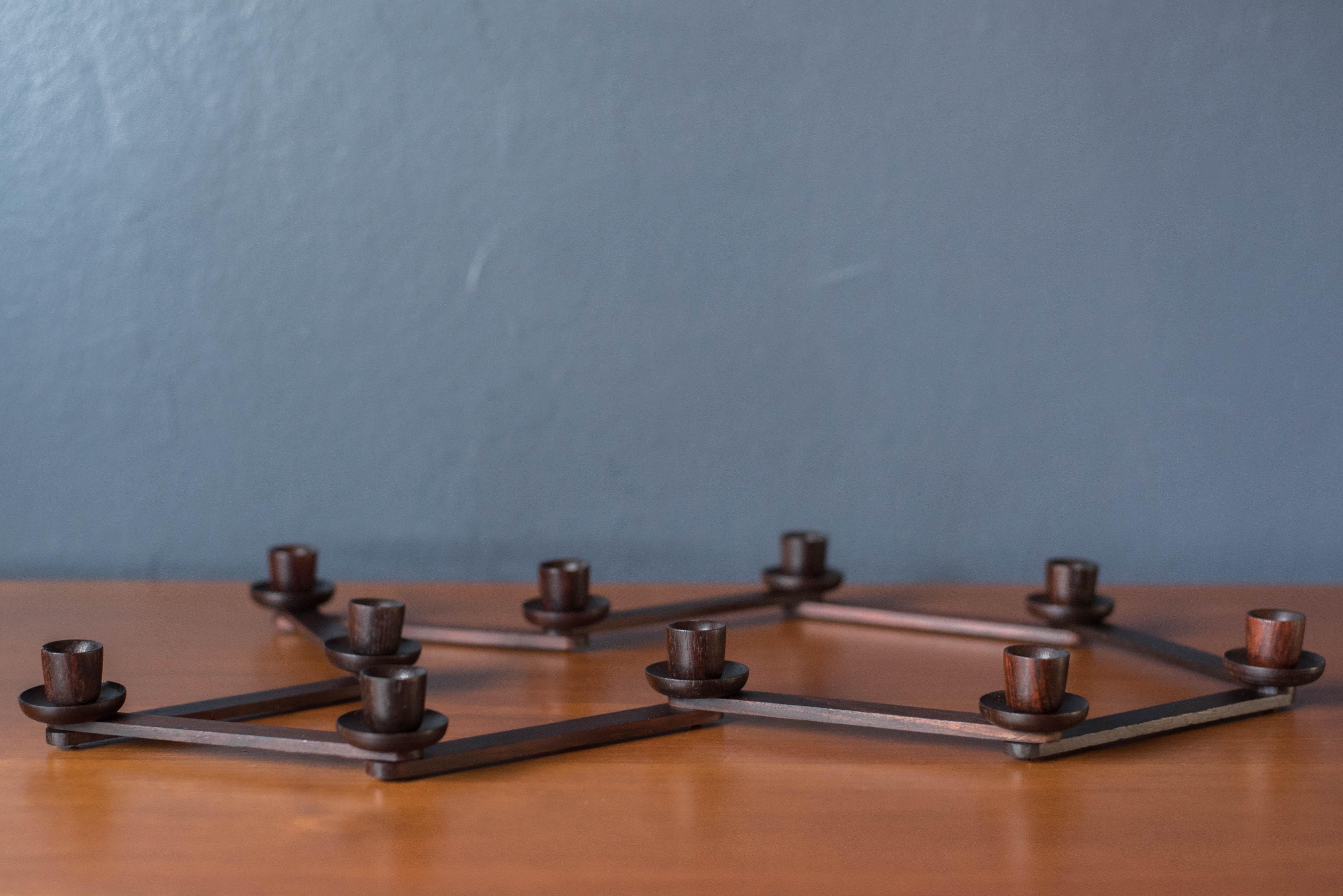 Mid-Century Modern centerpiece candleholders in rosewood circa 1970's. This unique piece includes 10 candle settings that can be arranged in multiple configurations. Perfect for accessorizing a dining room tablescape or entryway console. Fits 1/2