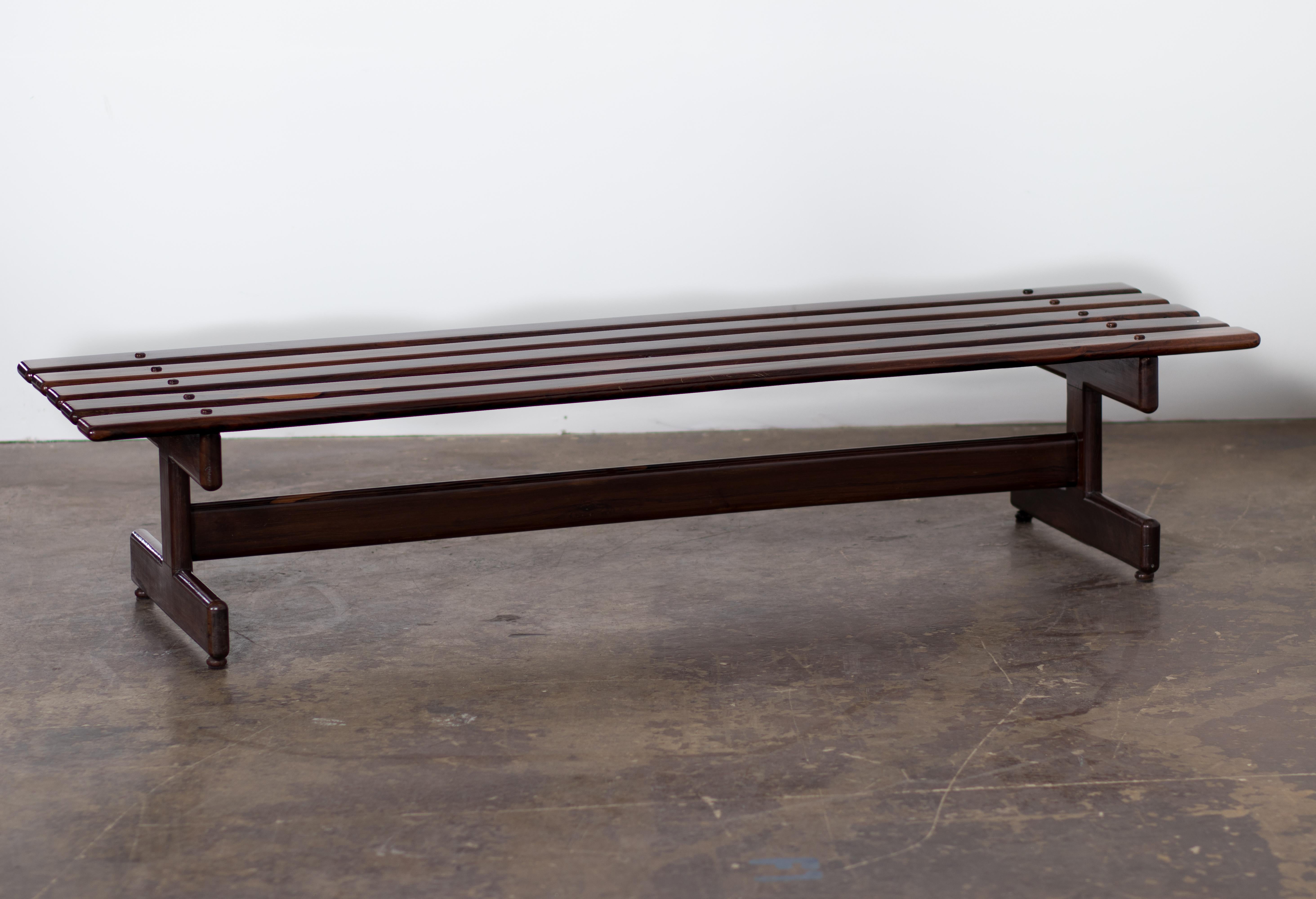 Cantù Móveis e Interiores LTDA produced this gorgeous bench in the 1960s. It consists of a very well-constructed piece in solid Rosewood, with slats rhythmically positioned supported by three feet with the characteristic shape used by the company in