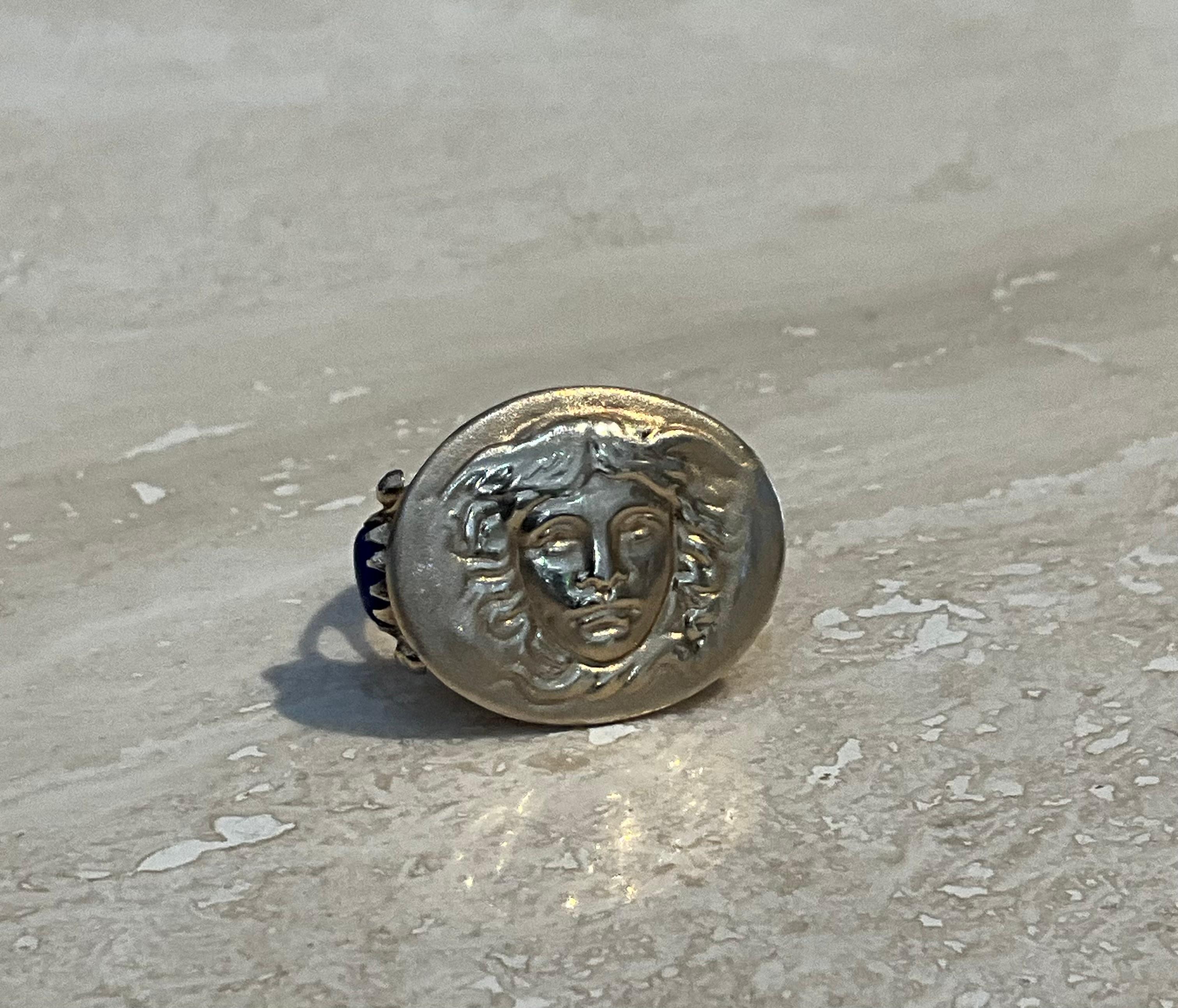 Capture timeless elegance and artistry with this stunning Vintage Ross-Simons Italian Tagliamonte Lapis Medusa Ring in 18kt gold over sterling. A true statement piece, this ring showcases a rich lapis lazuli gemstone paired with the intricate design