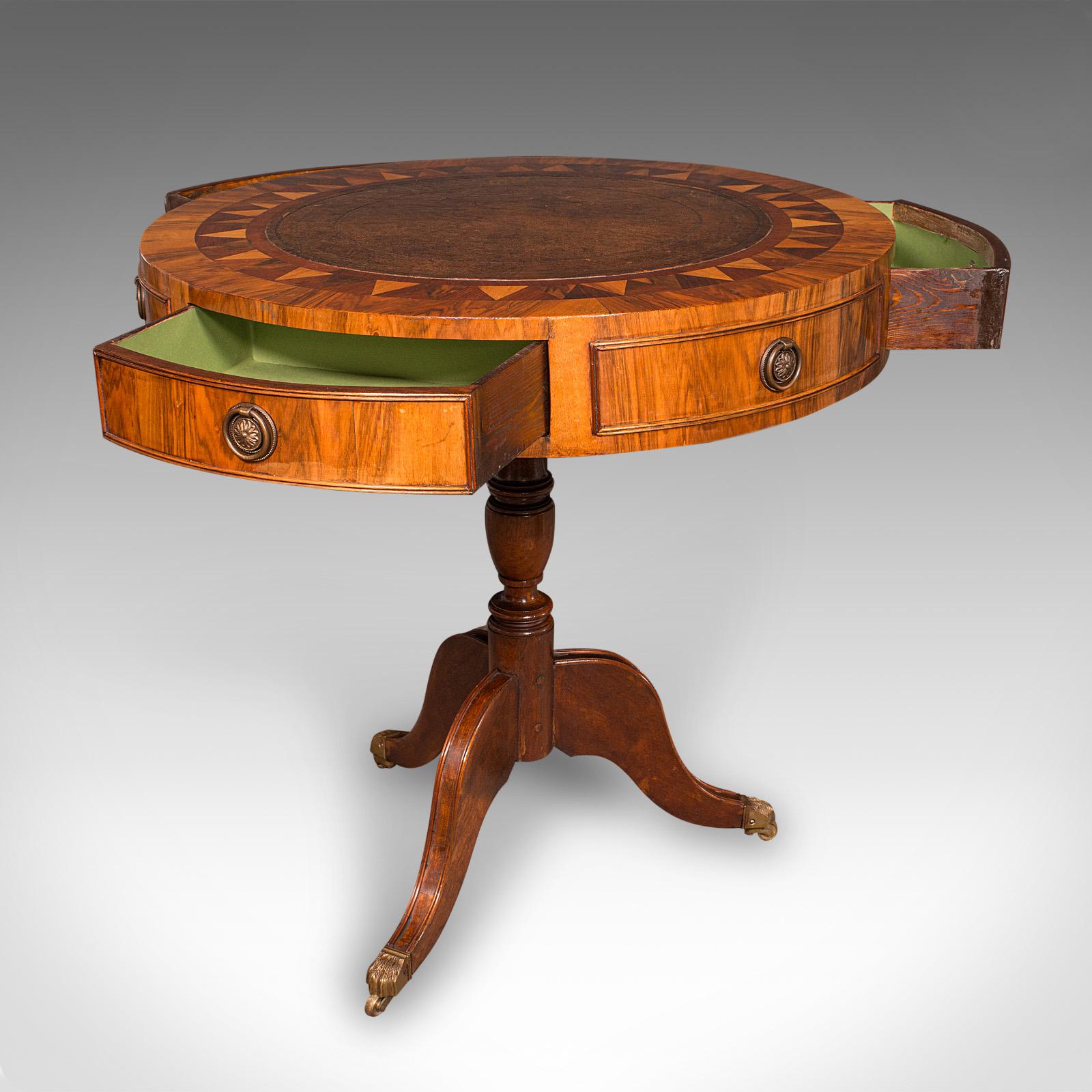 This is a vintage rotary centre table. An English, walnut and specimen wood inlaid game or writing table in Regency revival taste, dating to the late 20th century, circa 1970.

Fascinating Regency revival table with a striking rotary top and elegant