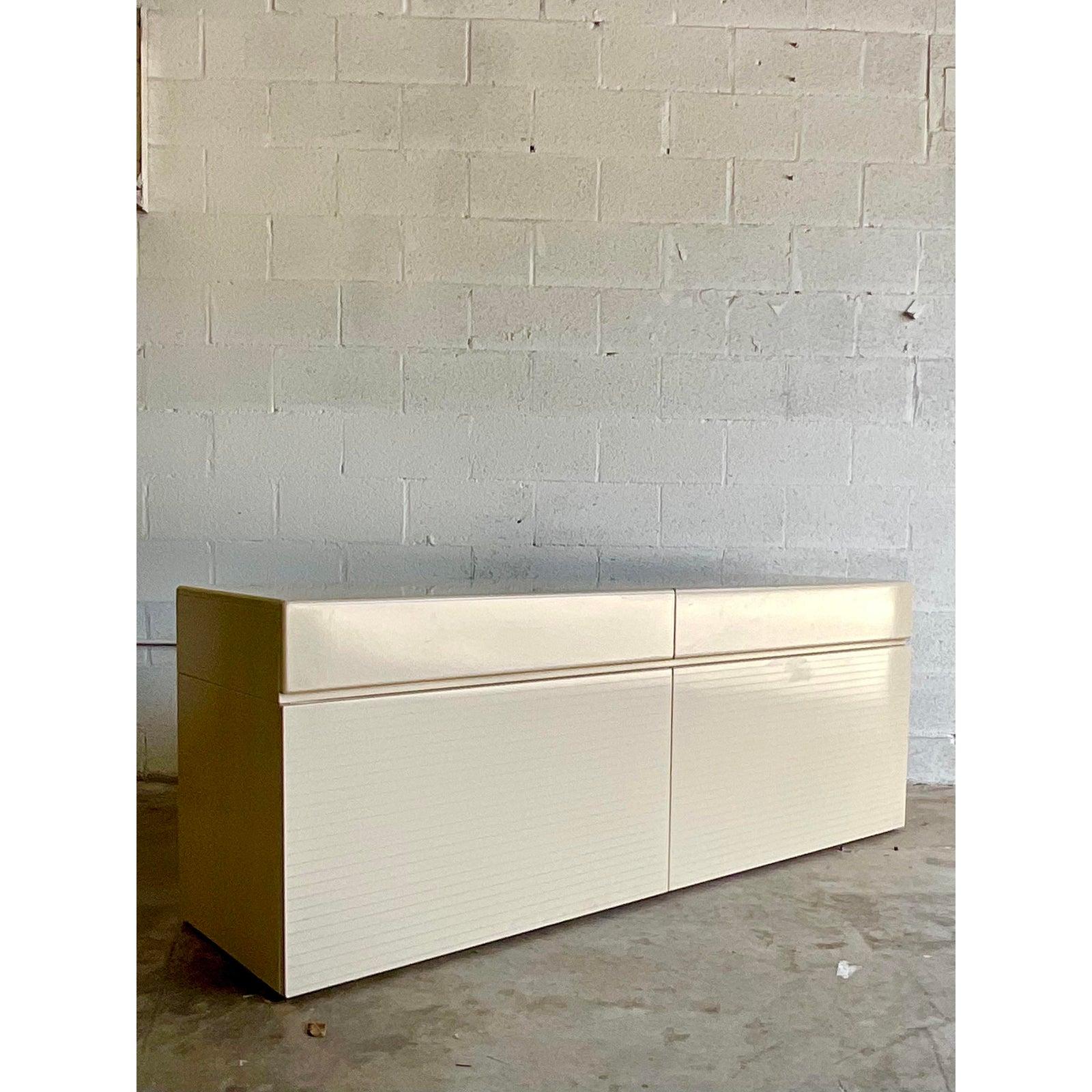 Incredible vintage Rougier credenza. Beautiful high glass lacquer in a cream finish with a silver pinstripe detail. Extra deep drawers for China storage. Just the chicest thing ever. Acquired from a Miami estate.