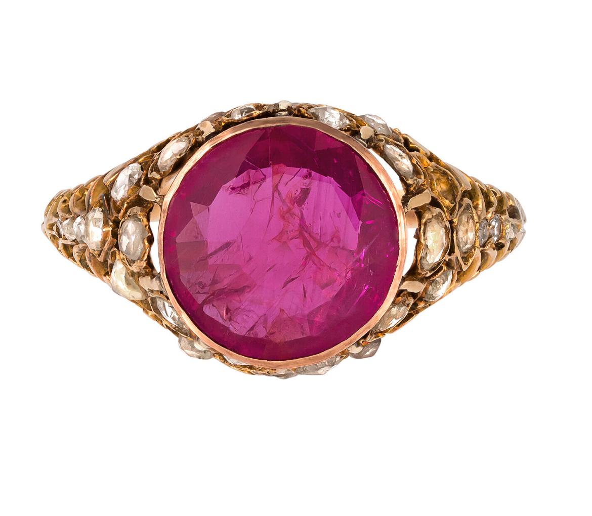 This sensational Vintage 18k yellow gold Burma ruby and diamond cocktail ring is set with One round mixed cut natural Burma Ruby of 3.15 carats and Twenty eight rose cut natural diamonds of 0.40 carats.

The total jewellery weight is 4.30 grams.