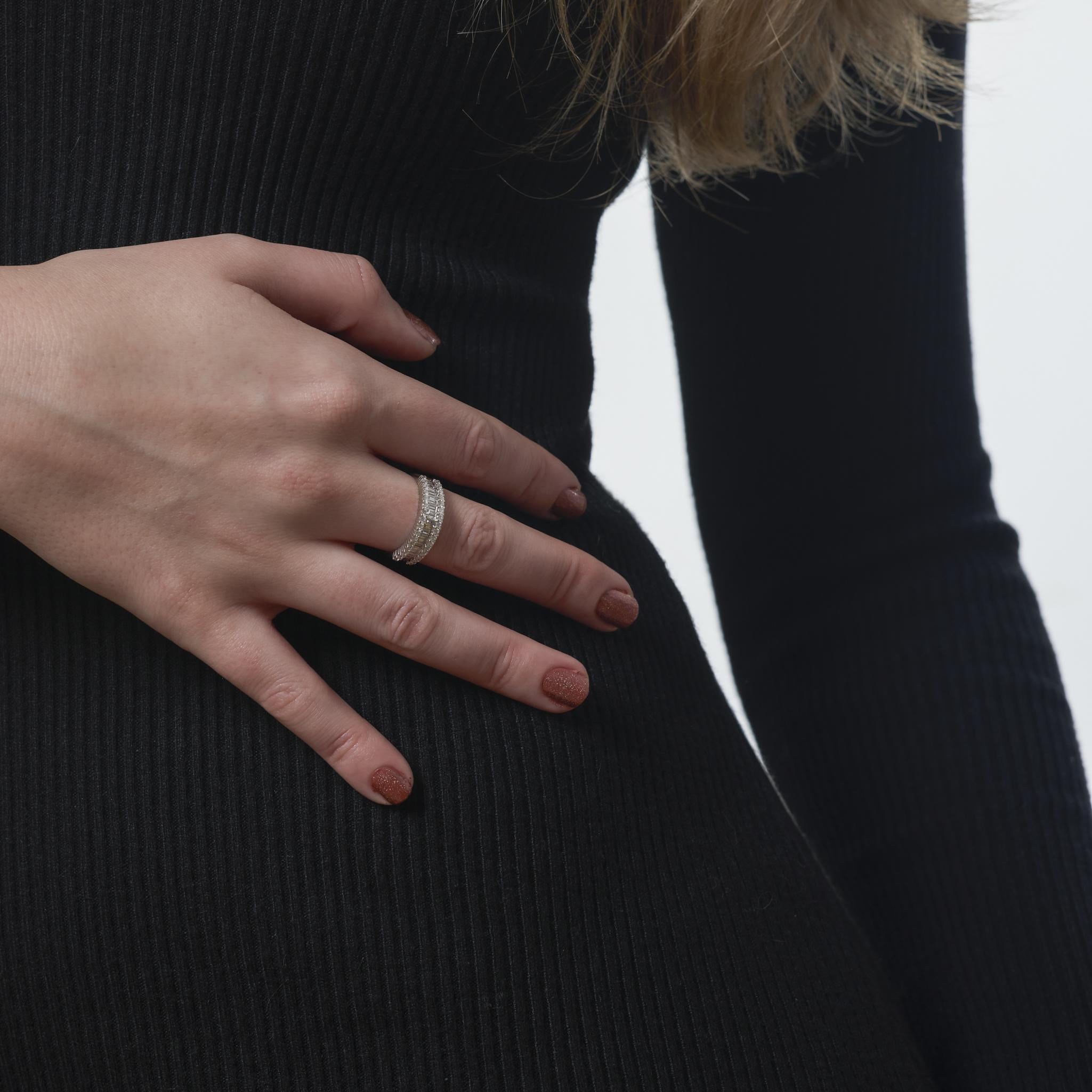 This vintage 14k white gold ring from the 1990’s dazzles with 32 round brilliant and 21 baguette cut diamonds weighing approximately .75 carats. The diamonds, F-G in color and VS in clarity, create a refined interplay of brilliance and geometry,