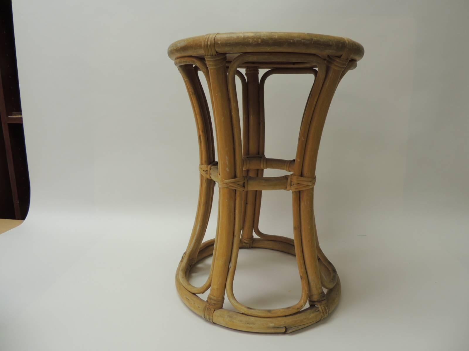 Vintage round bamboo and rattan side table with basket weave top details.
Undulating bent bamboo legs and rattan details.
Size: 14 x 18.5 H.