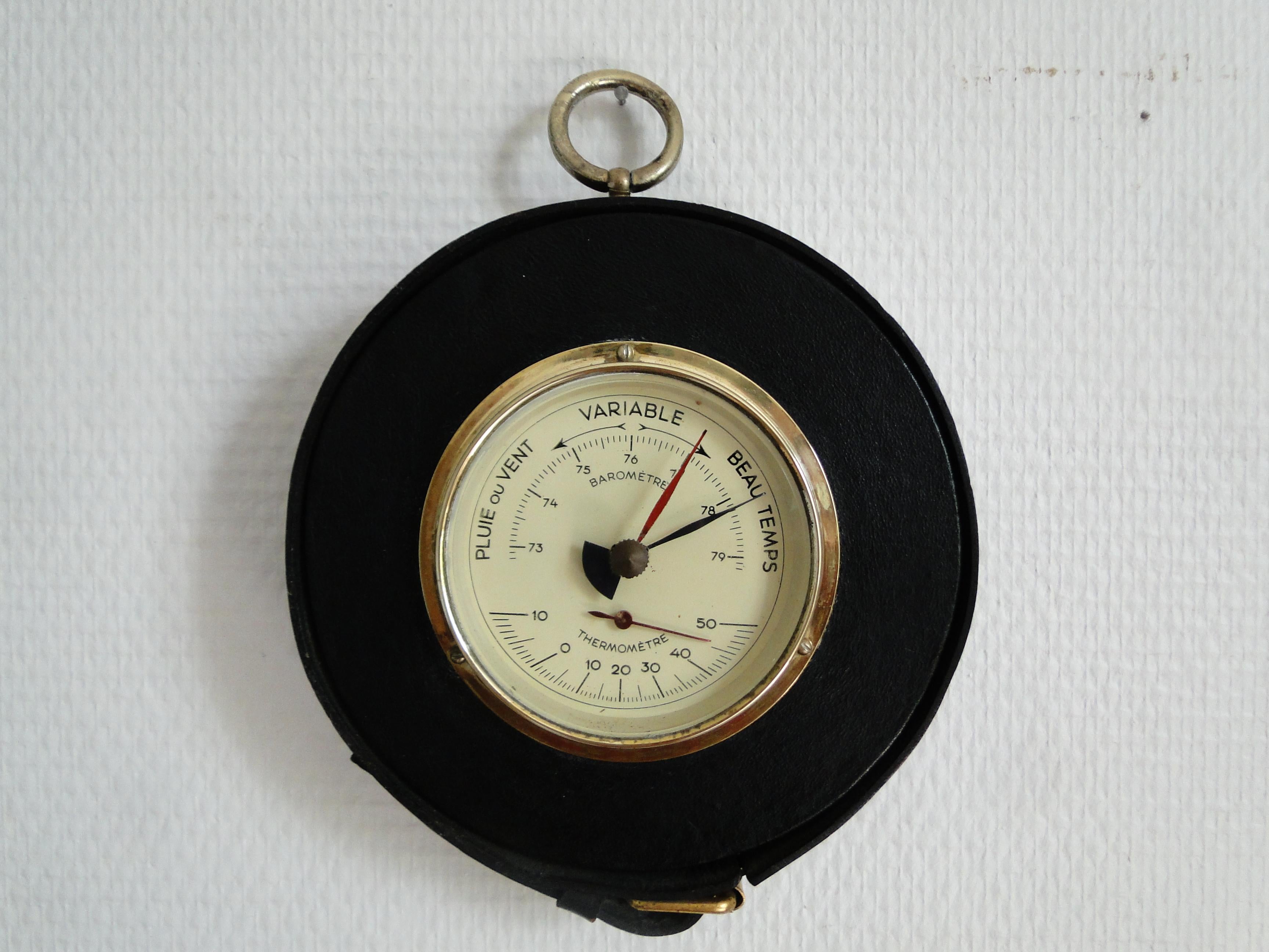 Barometer and thermometer by Jacques Adnet, around 1950 Barometer in brass, glass and saddle stitched black leather. Everything is in very good condition, only the barometer works.