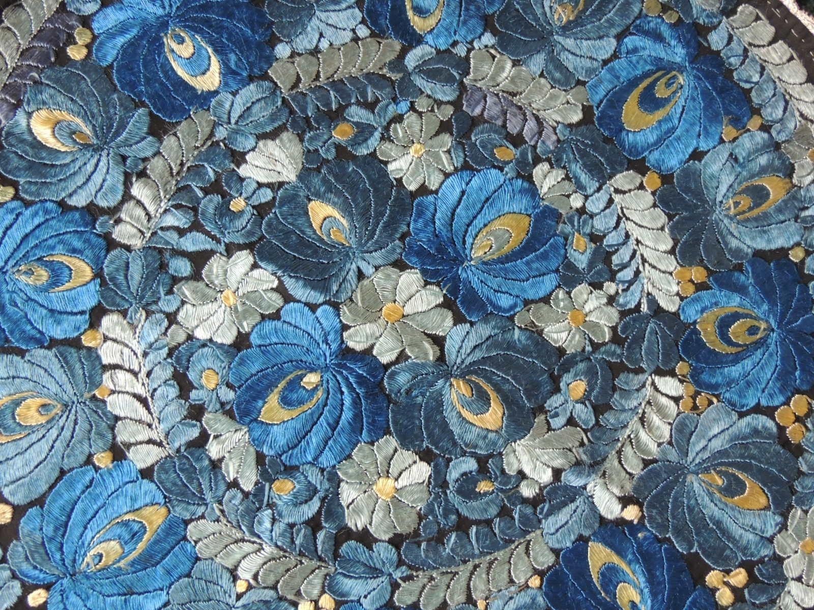 Vintage round blue and black silk embroidered table topper.
Floral and vines pattern in various shades of blue with a braided
woven trim all around.
The underside is brighter.
Ideal for a table or a decorative pillow.
Size: 21