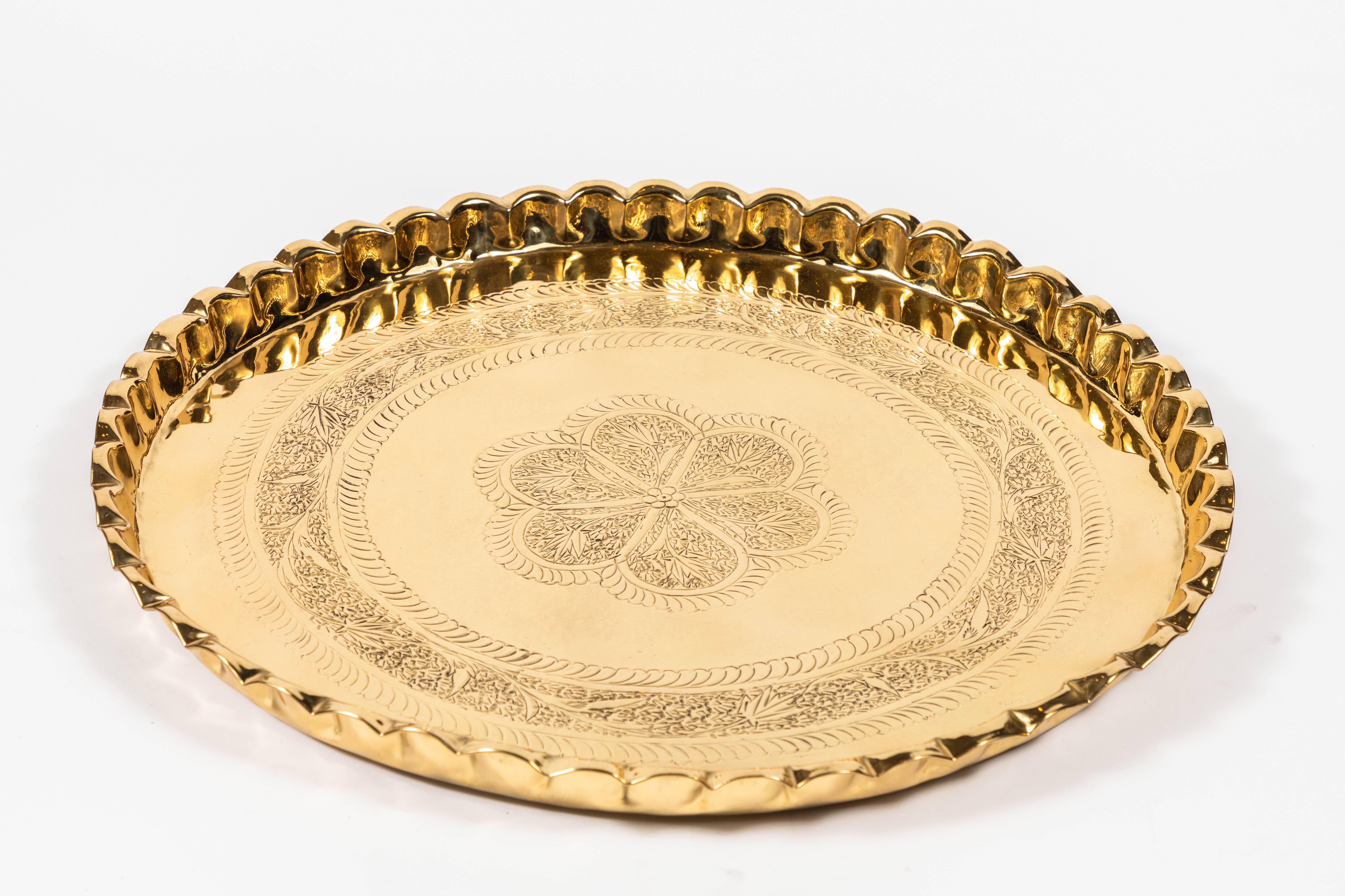 Vintage round brass tray with fluted edges.