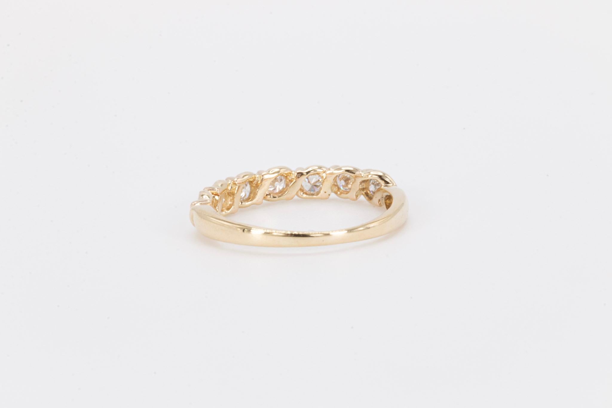 Vintage Round Brilliant Diamonds in 18k Yellow Gold Band

A timeless and elegant vintage ladies’ ring crafted in solid 18k yellow gold, featuring seven round brilliant-cut natural diamonds that sparkle beautifully across the band. Each diamond is