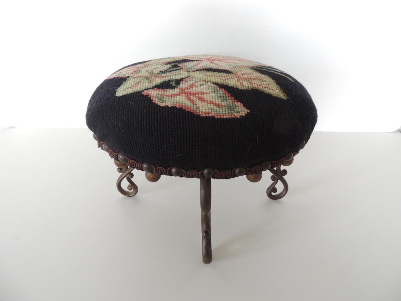 Vintage round tapestry footstool with brass legs.
Scrolled design brass legs with small wooden balls underside,
Depicting Caladium 