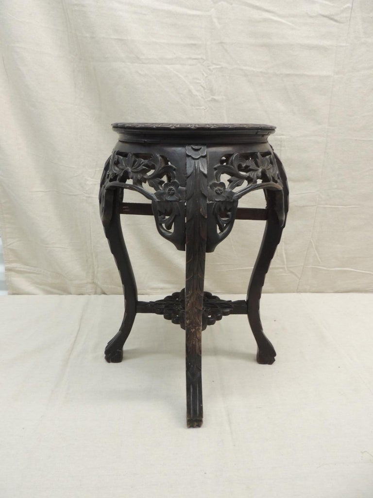 Vintage round Asian table
Plant stand on drinks table, hand carved details and inset soap stone top.
Small shelf on the bottom
Size: 14 x 14 x 19 H (Top 11 D).
 