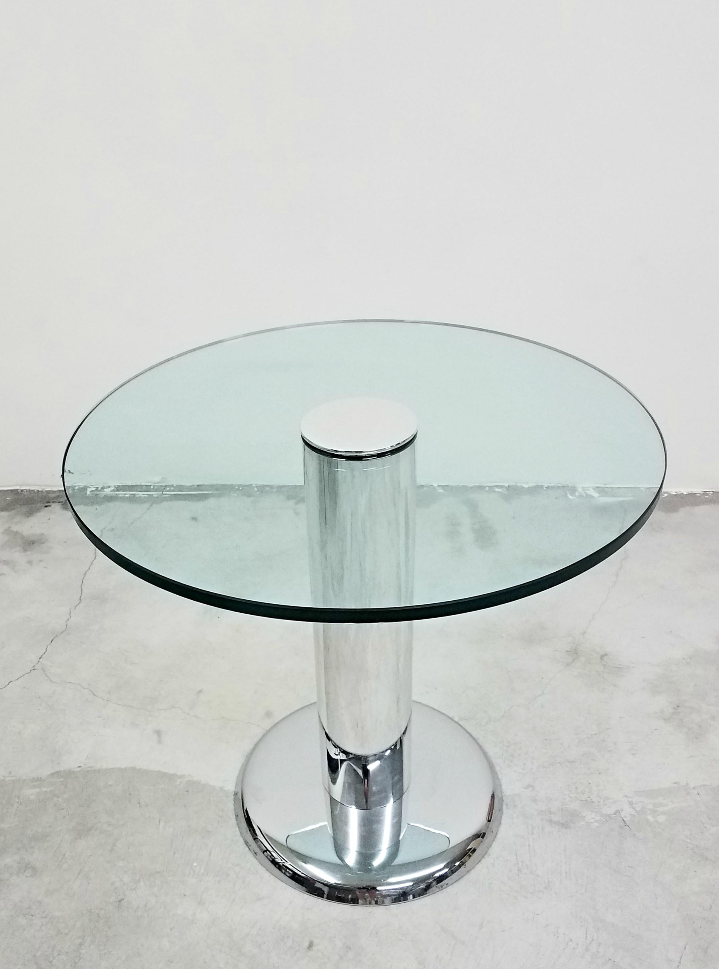 Absolutely gorgeous, polished chrome and glass pedestal table. A smaller table, but not small on style. Perfect size card or small game table. Ideal for between two chairs in a sitting area.

Although I am unsure of the manufacturer or designer, I