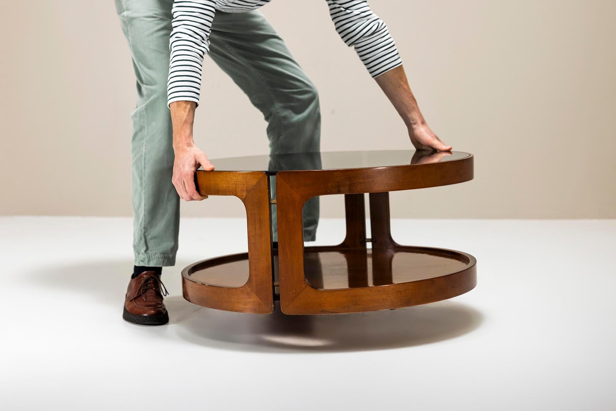 This round coffee table, veneered in teak, blends elegance with mid-century design. Its timeless silhouette fits effortlessly into both modern and classic interiors, showcasing a perfect balance between form and function. Crafted with care, the teak