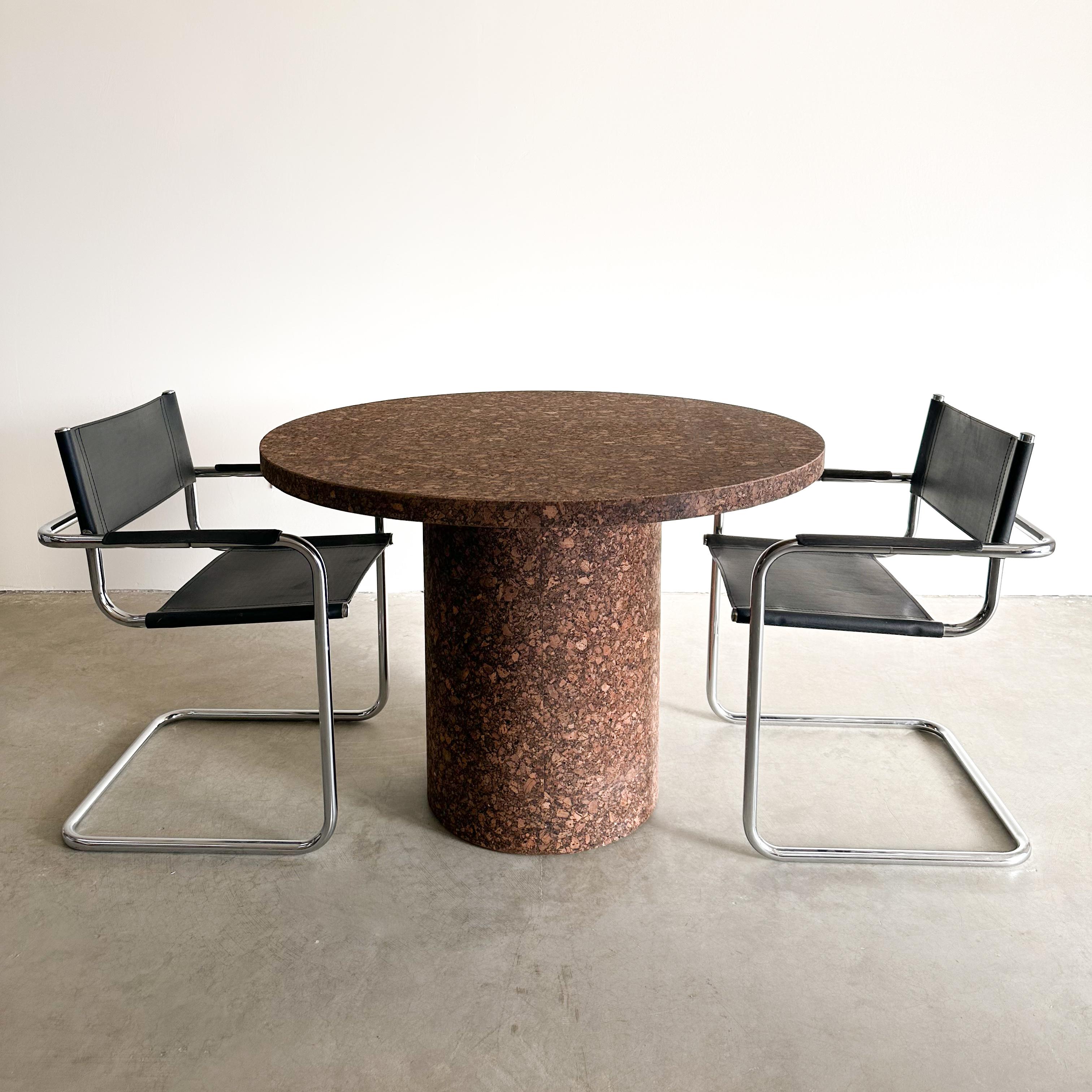Vintage Round Cork Dining Table.
The structure is made out of wood and has been veneered with cork. Seats 4 comfortably.

Color: Natural Cork (similar to burlwood)

Measurements:
Diameter: 42