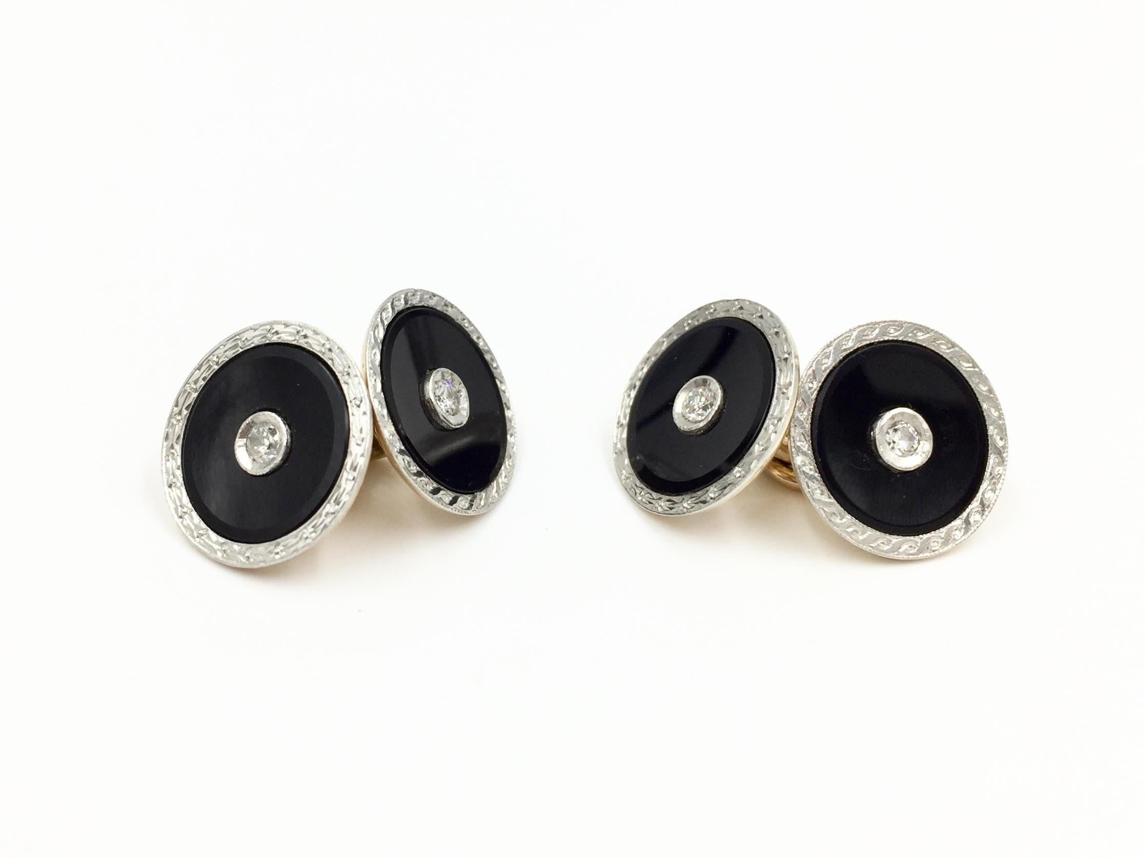 Circa 1960's in original vintage box. Well-made engraved platinum and 14 karat yellow gold onyx and diamond round cuff links with two sizes of matching shirt stud sets. Discs on cuff links have a diameter of 14mm with an approximate .07 carat round