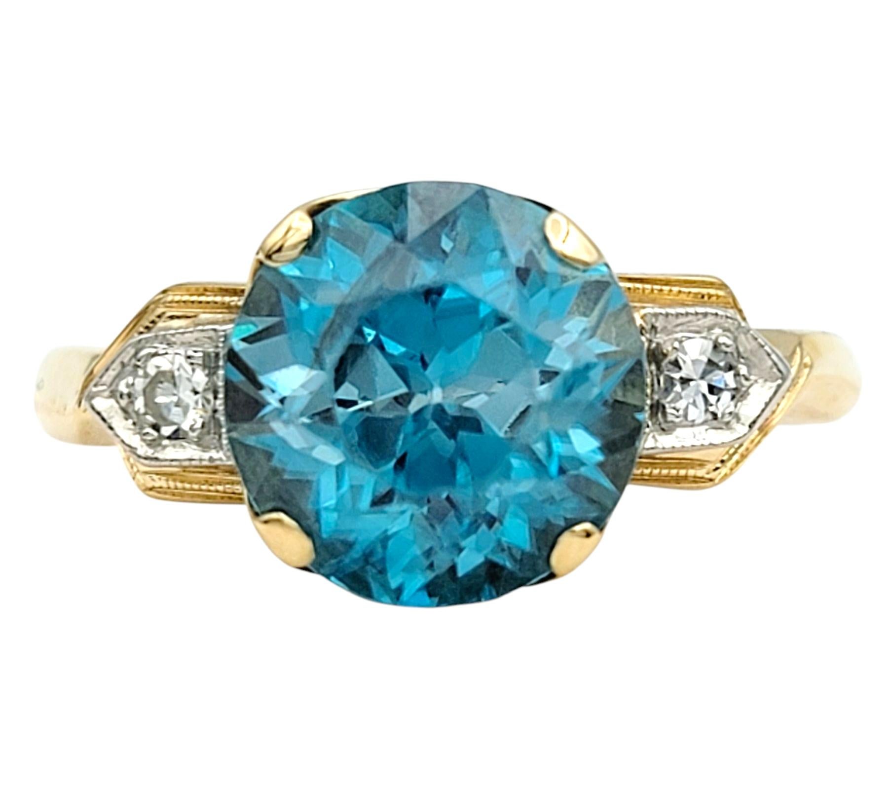 Ring Size: 7

This eye-catching vintage three-stone ring centers a vivid round-cut blue zircon, known for its brilliant sparkle and rich saturation. The stone’s intense blue tone is further accentuated by a bold yellow gold setting that enhances the