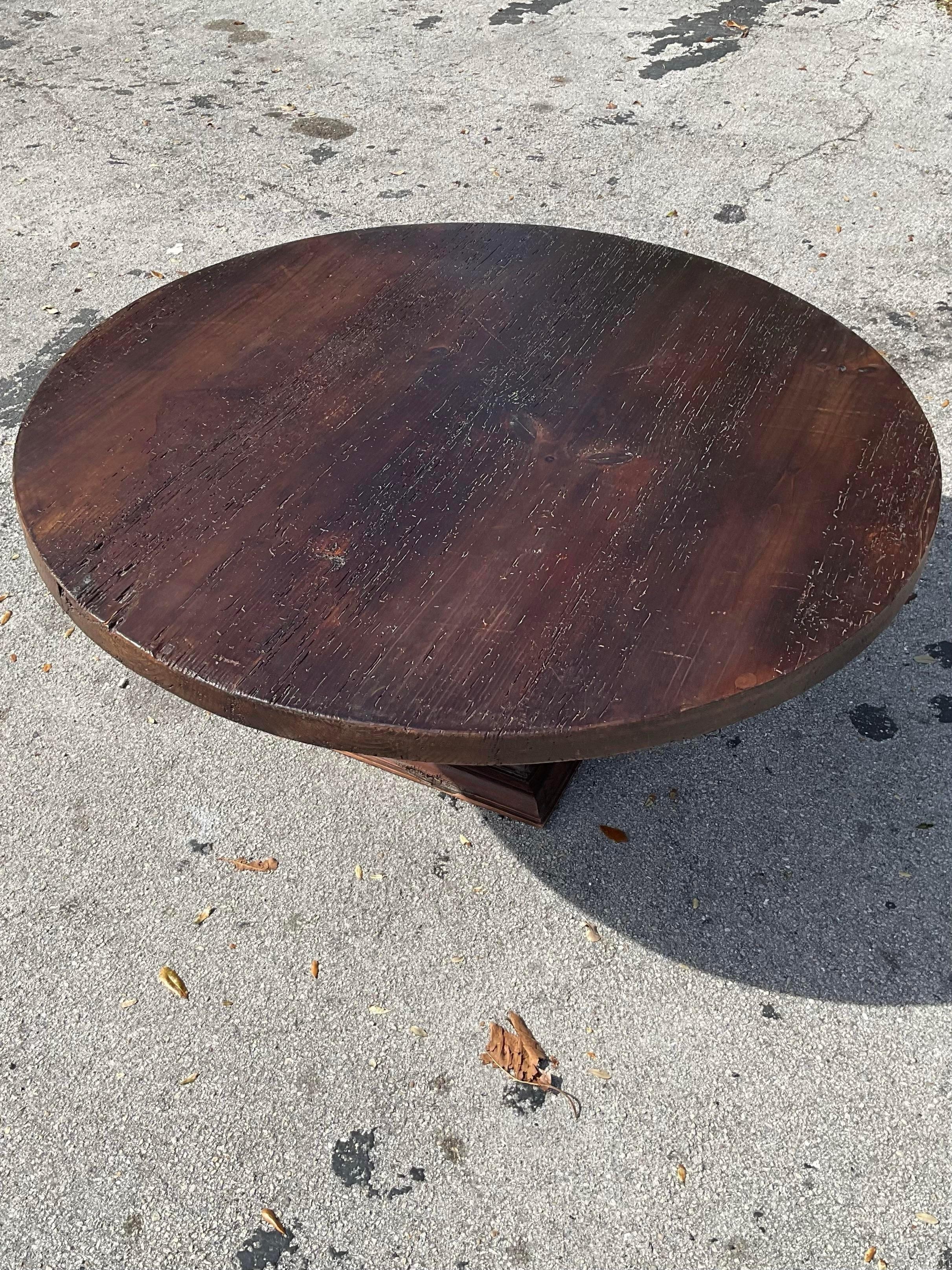 Gorgeous deep grain farm style round table. Height of the table lends itself to an entry center table at 28” however easily heightened to dining height. Incredibly rich dark stain on the open grain thick wood top, extremely elegant simple pedestal