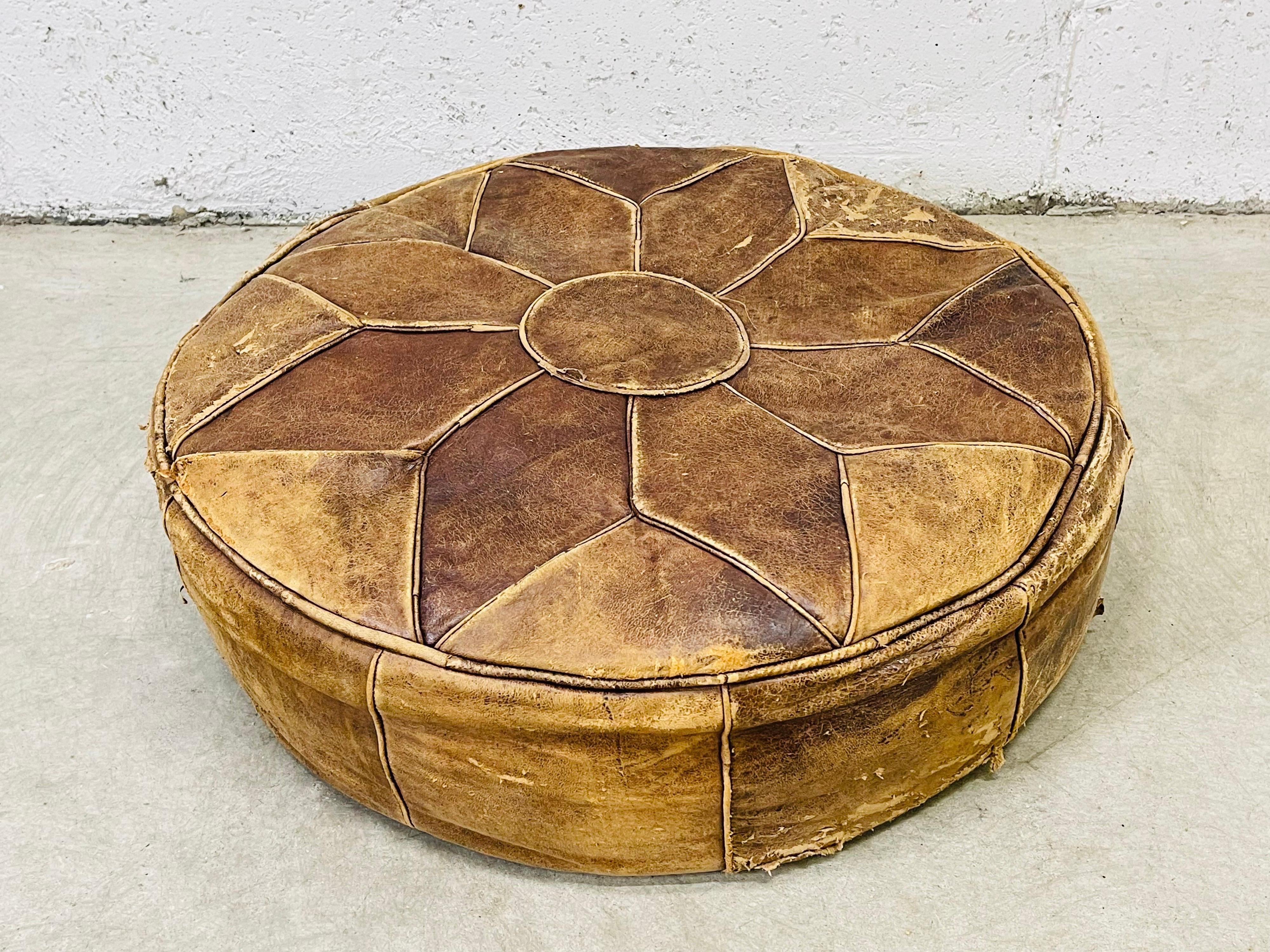 Vintage 1980s distressed leather hassock with a star design. The hassock is sturdy. No marks.