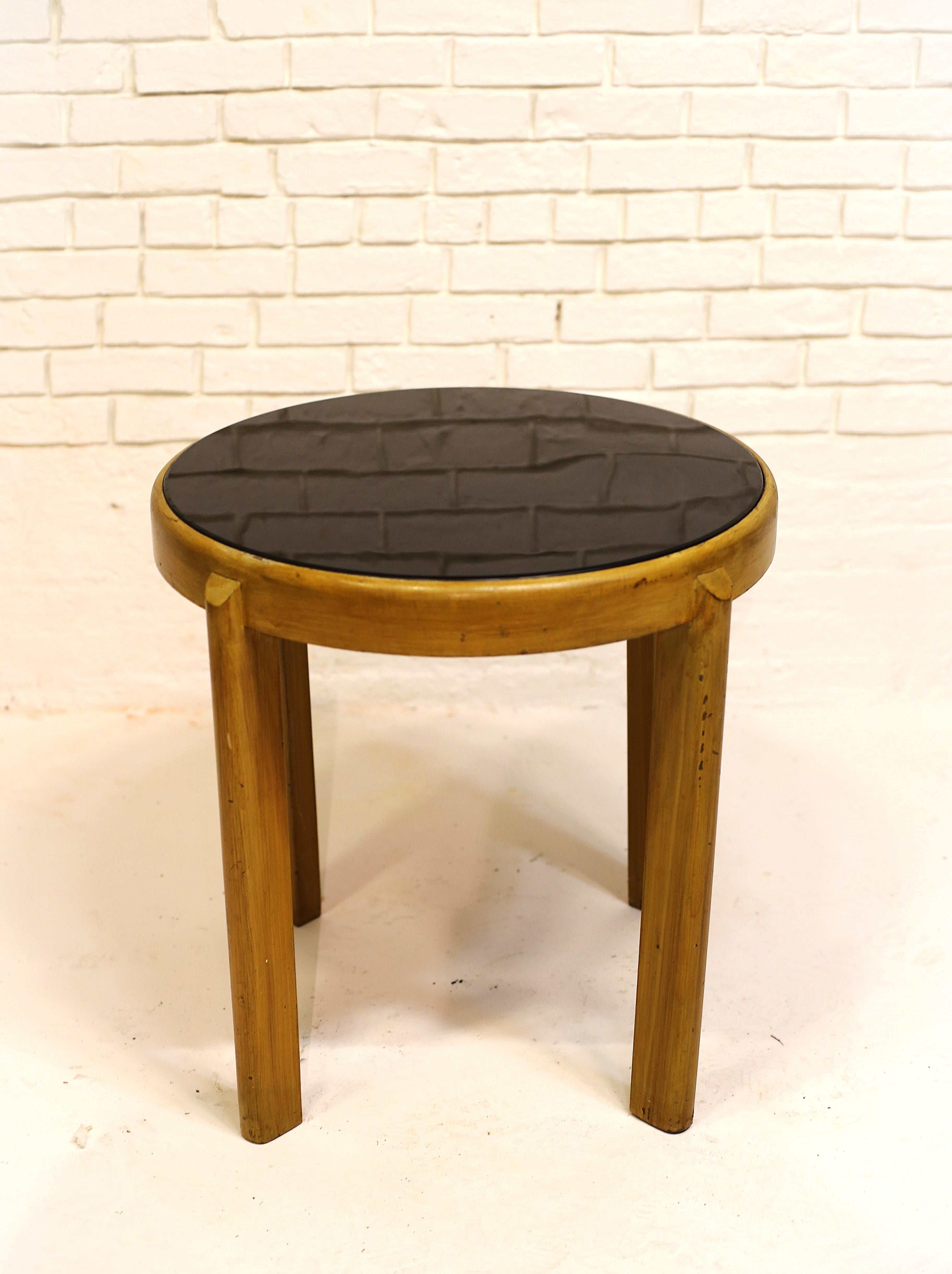 Nicely designed round table with sleek, elm construction and a sharp smoked grey glass top. 

Table is solid and sturdy. 