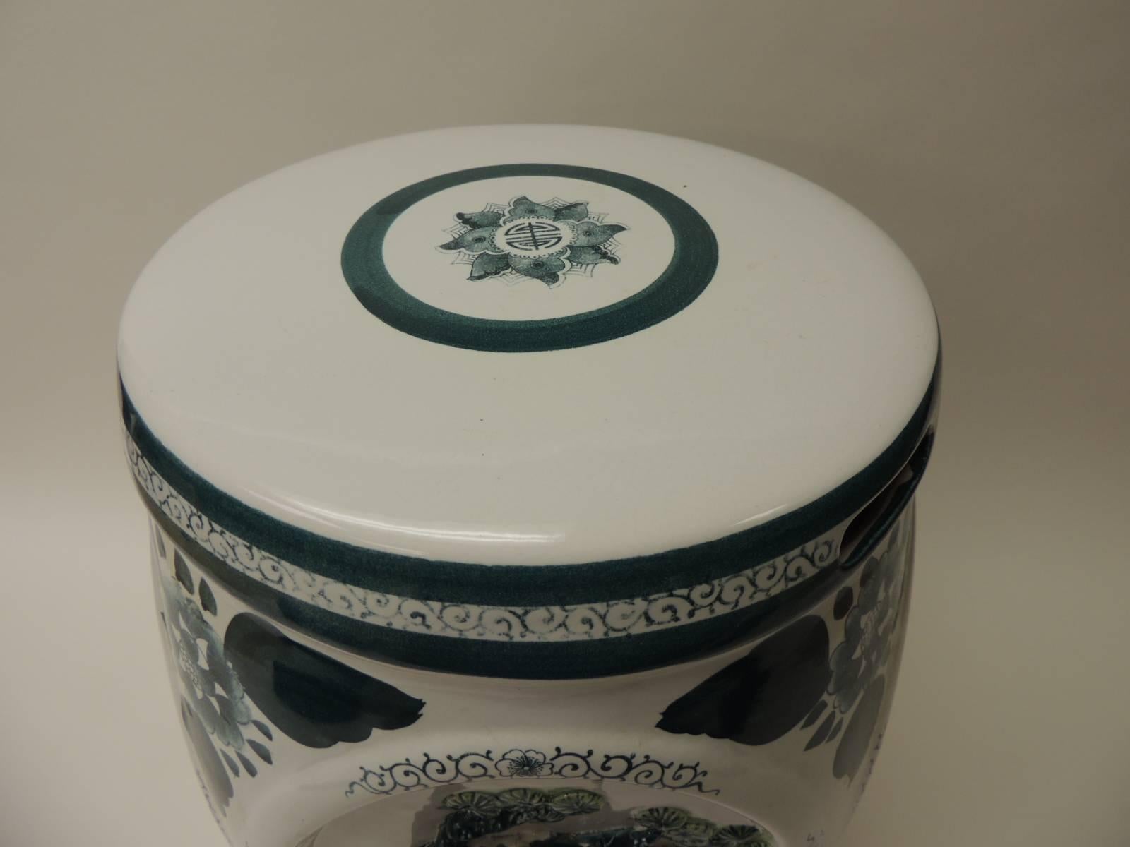 Vintage round hand-painted green and white ceramic Chinese export garden stool.  The four sides of this vintage round hand-painted white and green garden stool are different. One side depicts an oval medallion style with bamboo. The other side