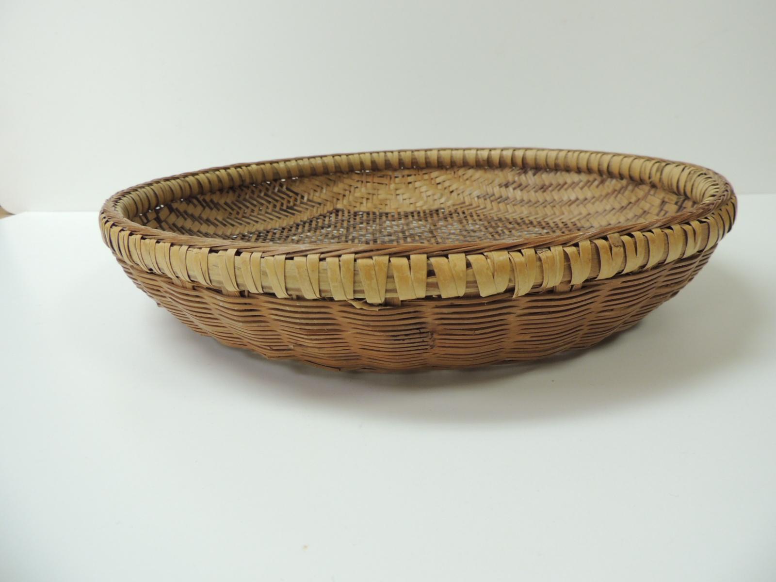Vintage round handwoven Indonesian decorative basket
Artisanal basket with an intricate three-dimensional wall or bread basket with deep rim.
Indonesia, 1980s
Size: 14 x 2.¾ H.

 