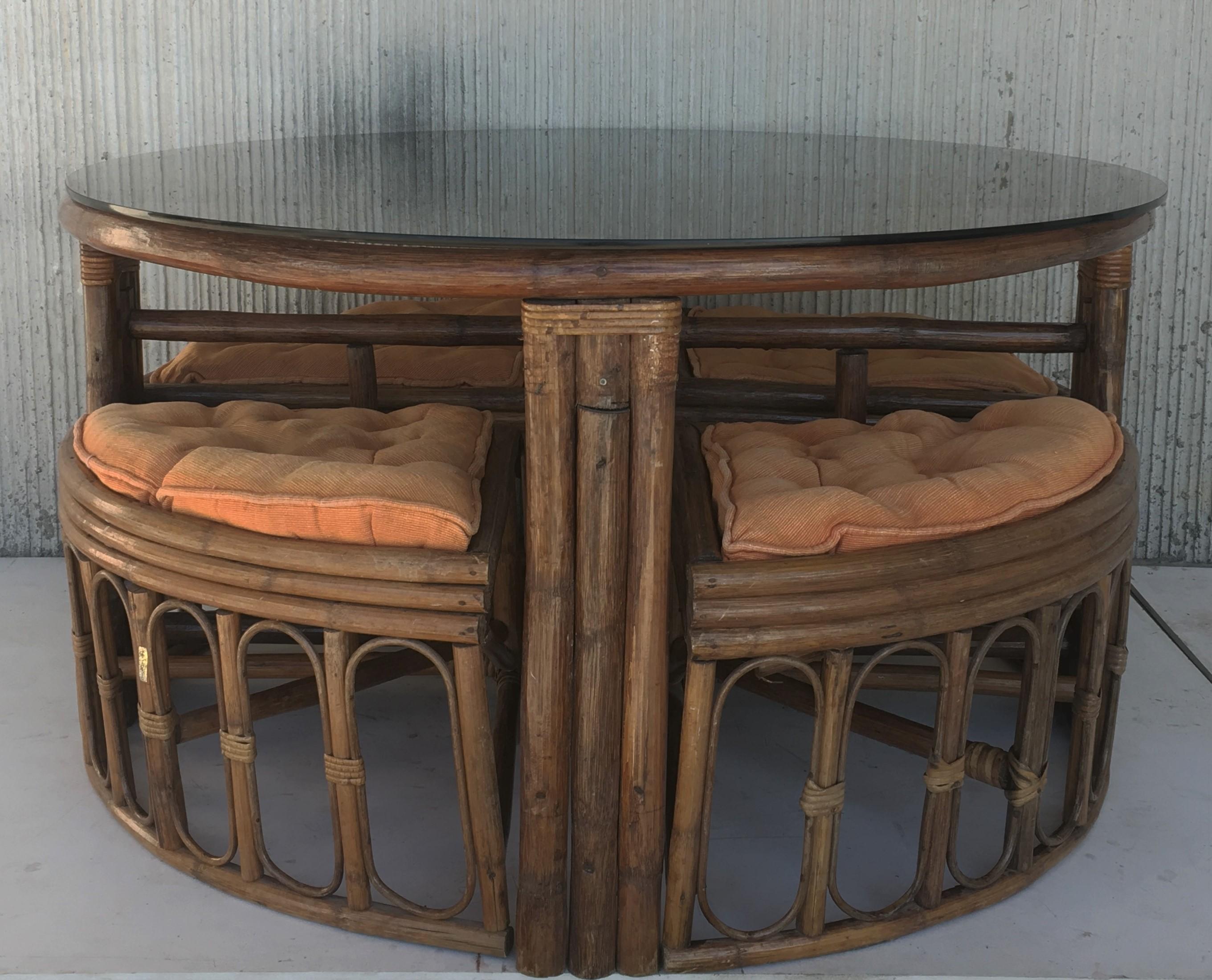 Vintage round McGuire style bamboo and glass dining table with four stools.
     