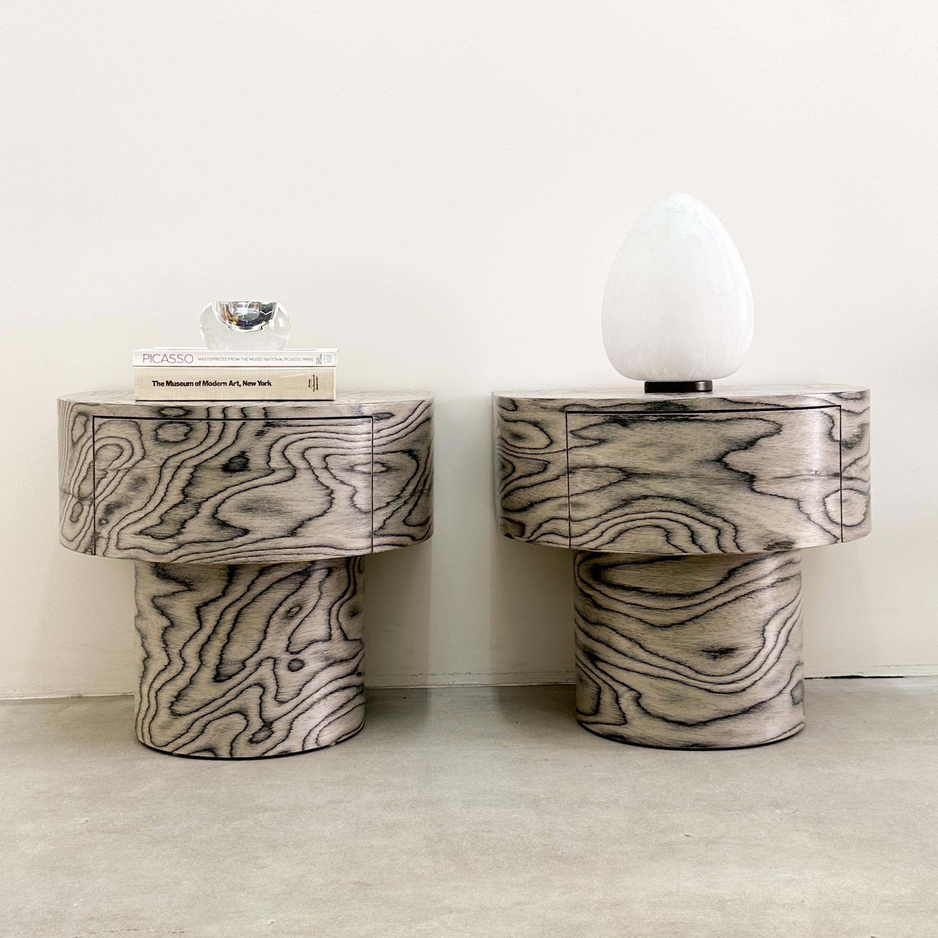 Vintage Round Nightstands Featuring Ettore Sottsass Veneer.

The vintage nightstands have been re-veneered with the original Ettore Sottsass pattern from 1985.
ALPI manufactures the distinctive veneer.
It has been sealed with a satin finish for