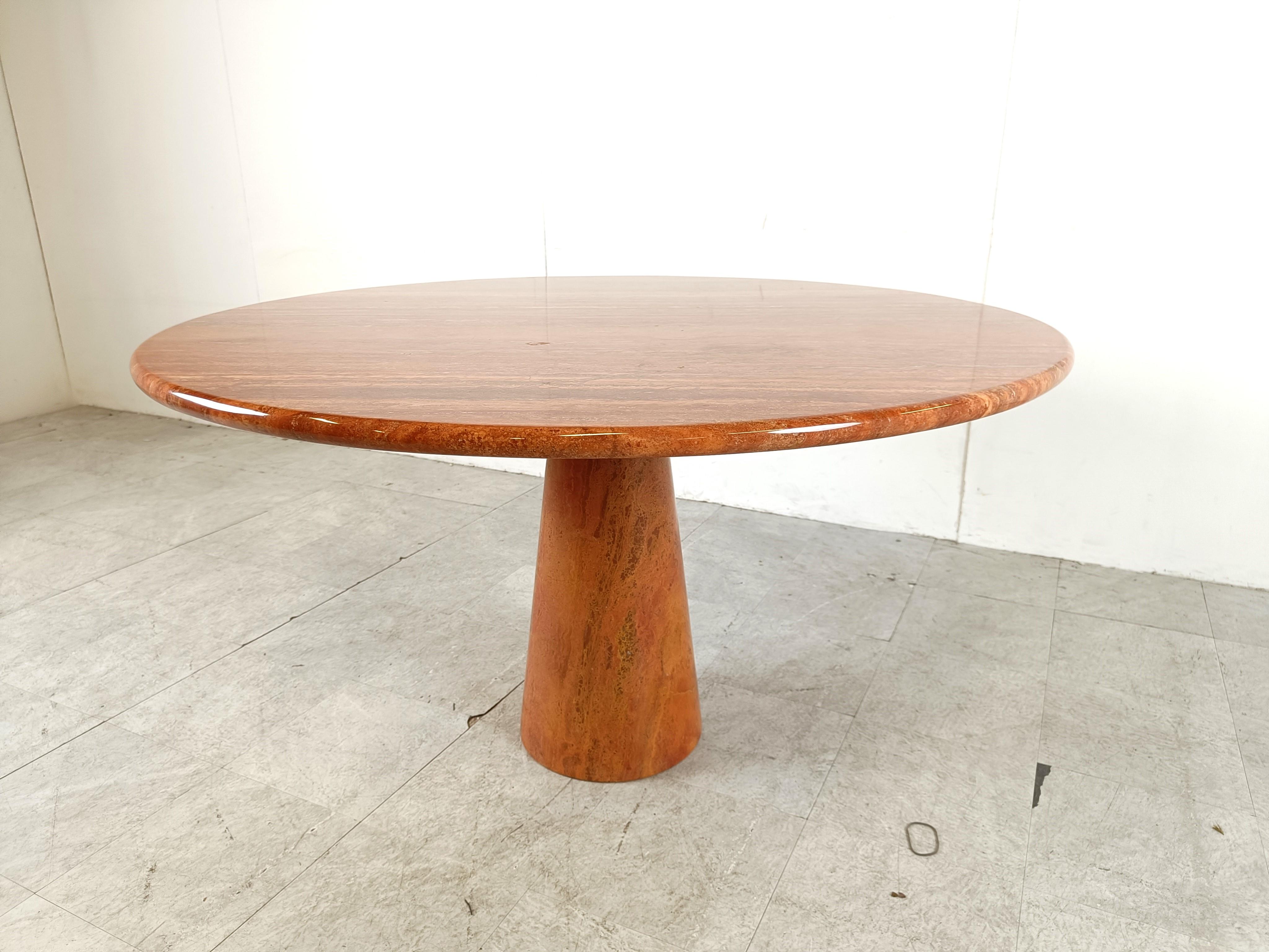 Remarkable red travertine dining table with a conical center base and a beautiful round table top.

The table was made in the 1970s, it's very much in the style of Angelo Mangiarotti

Beautiful natural red travertine stone with a gorgeous natural